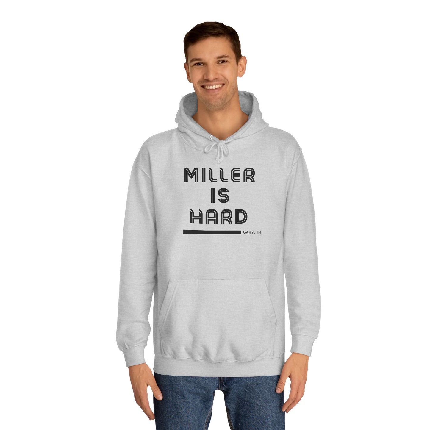 A light blue unisex college hoodie from Printify features the bold black text "MILLER IS HARD" on the front, with "GARY, IN." in smaller letters below. This hoodie is equipped with a front pocket and adjustable drawstrings, ideal for those who appreciate the Miller Beach style.