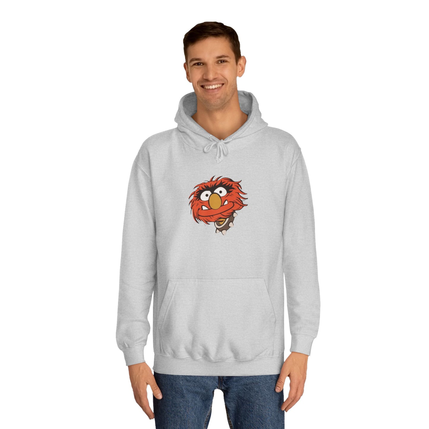 This comfy unisex college hoodie by Printify showcases a vibrant design of a cartoon character with wild orange hair, bulging eyes, and a broad grin on the front, embodying that lively spirit. It's like wearing the Animal - The Muppets hoodie without sacrificing comfort.