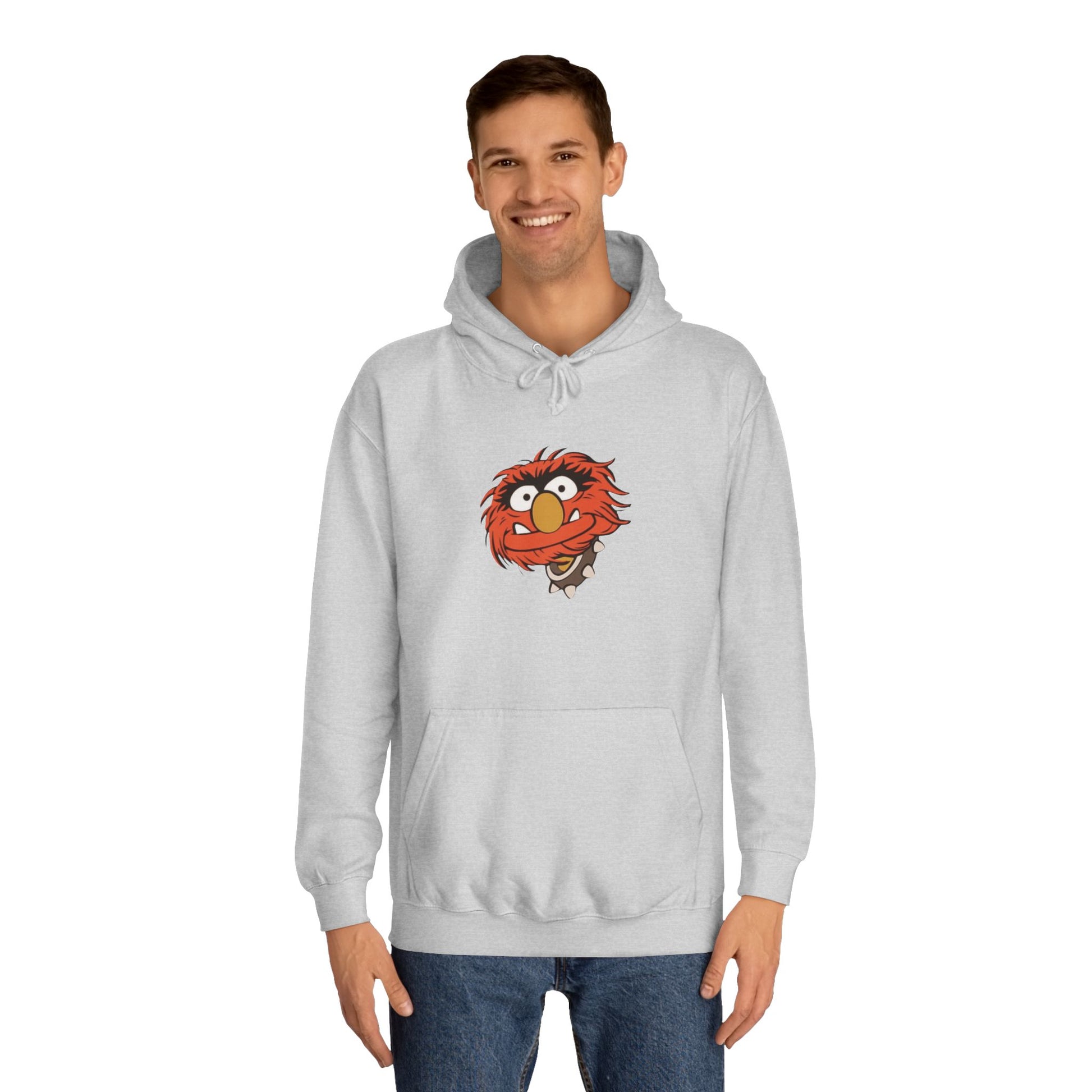 This comfy unisex college hoodie by Printify showcases a vibrant design of a cartoon character with wild orange hair, bulging eyes, and a broad grin on the front, embodying that lively spirit. It's like wearing the Animal - The Muppets hoodie without sacrificing comfort.