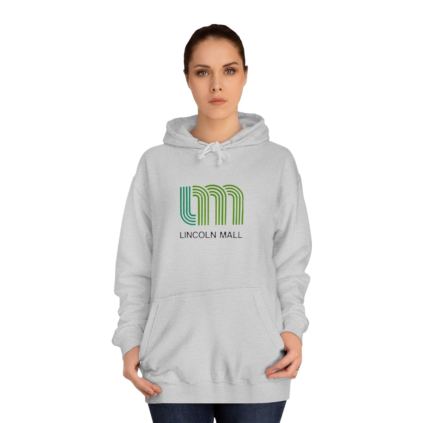 This unisex college hoodie by Printify features a gray design with a stylized green "LM" logo above the text "Lincoln Mall," inspired by the 1980s. It comes complete with a front pocket and drawstrings, capturing the retro style of Lincoln Mall, Matteson, IL.