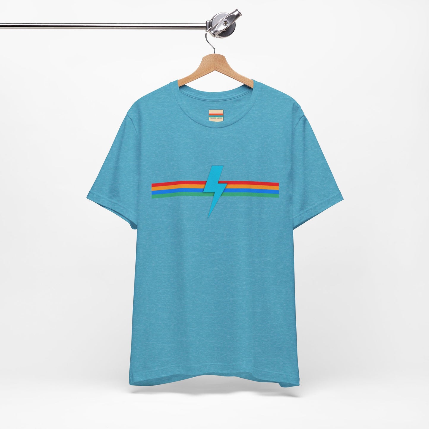 A neatly folded light green "SoCool Shirts OG Logo Retro - Unisex Jersey Short Sleeve Tee" from Printify, featuring a colorful horizontal stripe design across the chest in blue, red, green, and yellow with an original lightning bolt logo in the middle.