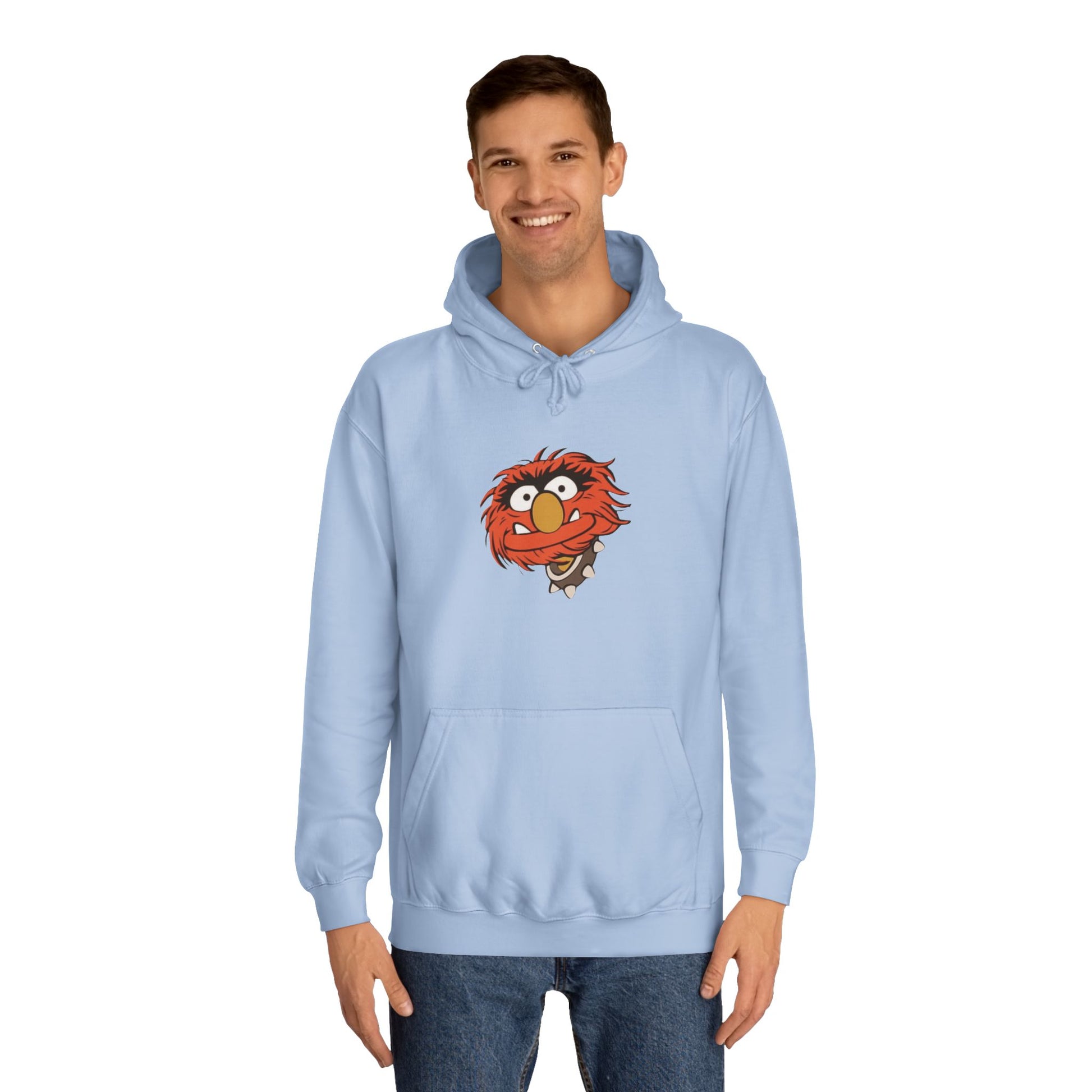 This comfy unisex college hoodie by Printify showcases a vibrant design of a cartoon character with wild orange hair, bulging eyes, and a broad grin on the front, embodying that lively spirit. It's like wearing the Animal - The Muppets hoodie without sacrificing comfort.