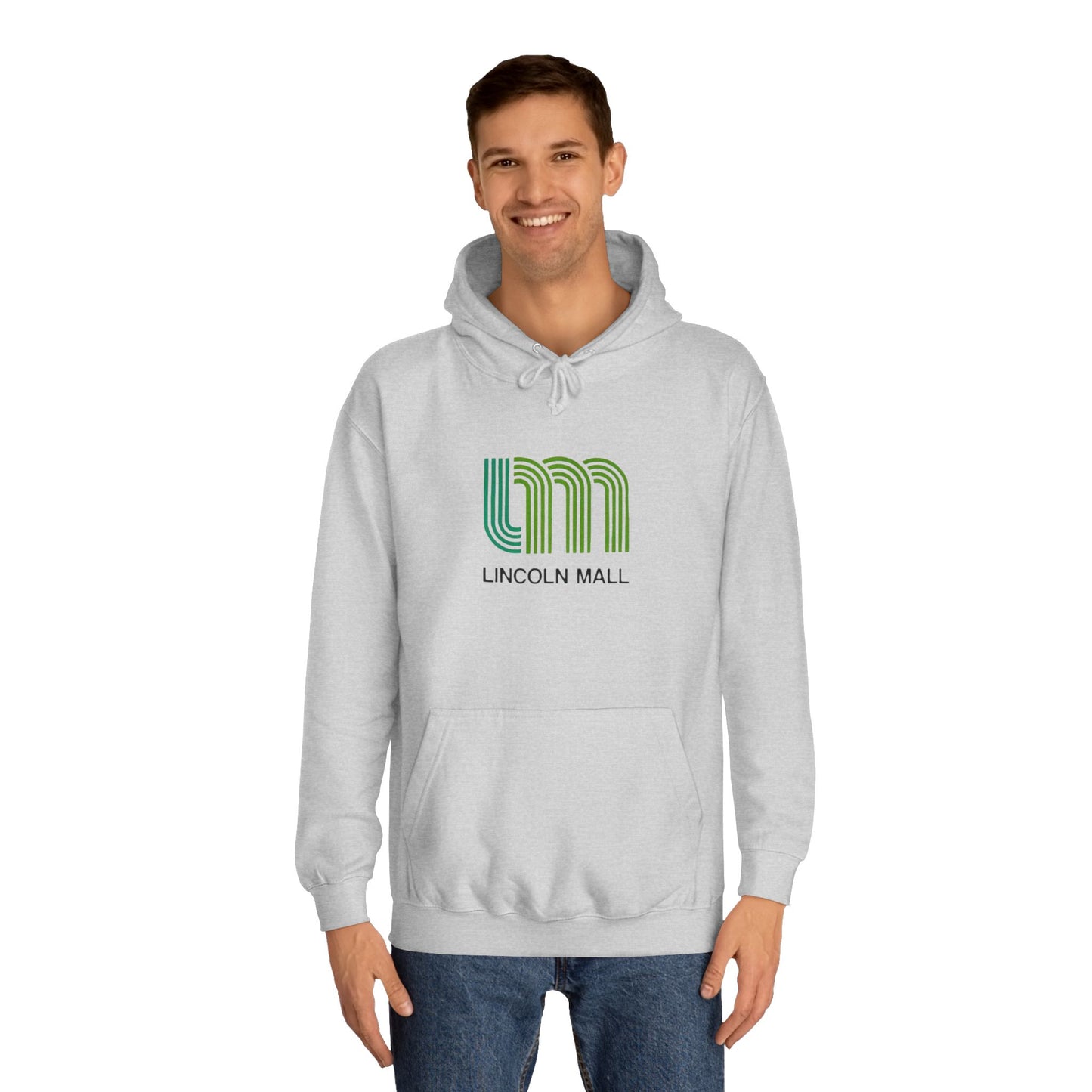 This unisex college hoodie by Printify features a gray design with a stylized green "LM" logo above the text "Lincoln Mall," inspired by the 1980s. It comes complete with a front pocket and drawstrings, capturing the retro style of Lincoln Mall, Matteson, IL.