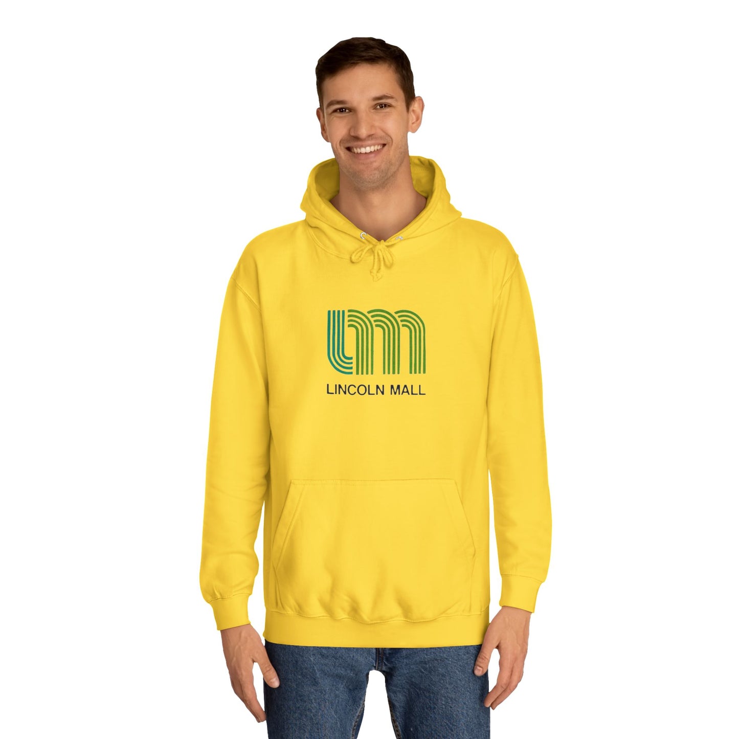 This unisex college hoodie by Printify features a gray design with a stylized green "LM" logo above the text "Lincoln Mall," inspired by the 1980s. It comes complete with a front pocket and drawstrings, capturing the retro style of Lincoln Mall, Matteson, IL.