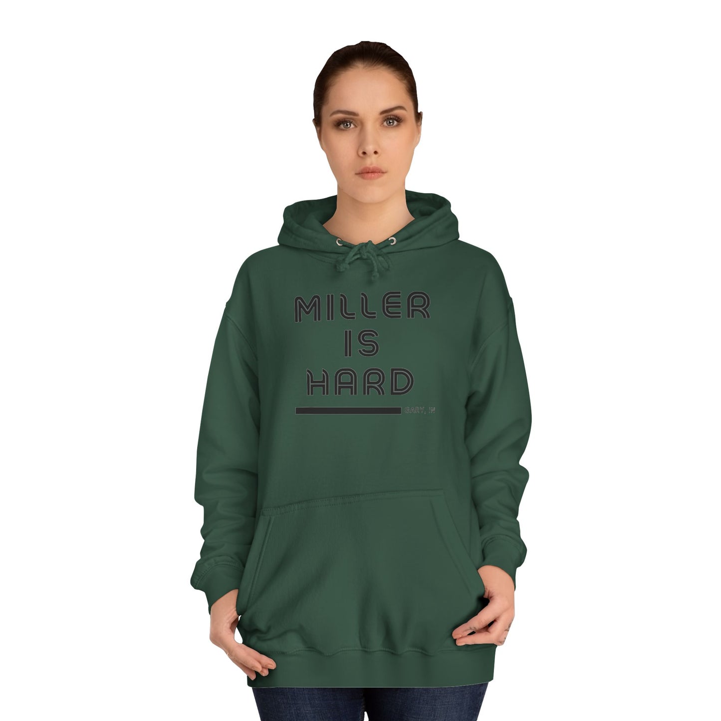 A light blue unisex college hoodie from Printify features the bold black text "MILLER IS HARD" on the front, with "GARY, IN." in smaller letters below. This hoodie is equipped with a front pocket and adjustable drawstrings, ideal for those who appreciate the Miller Beach style.