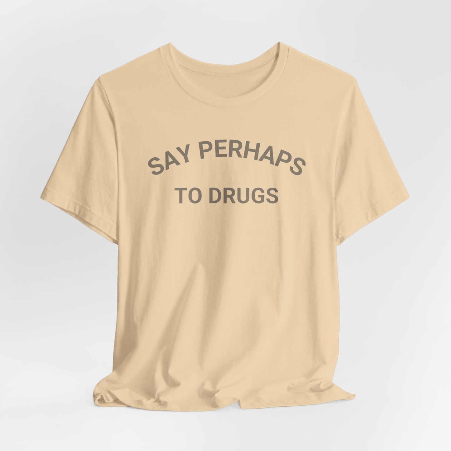 A Printify "Say Perhaps to Drugs" unisex jersey short sleeve tee in blue, featuring the text "SAY PERHAPS TO DRUGS" in dark letters across the front. The soft cotton shirt is displayed against a plain white background.
