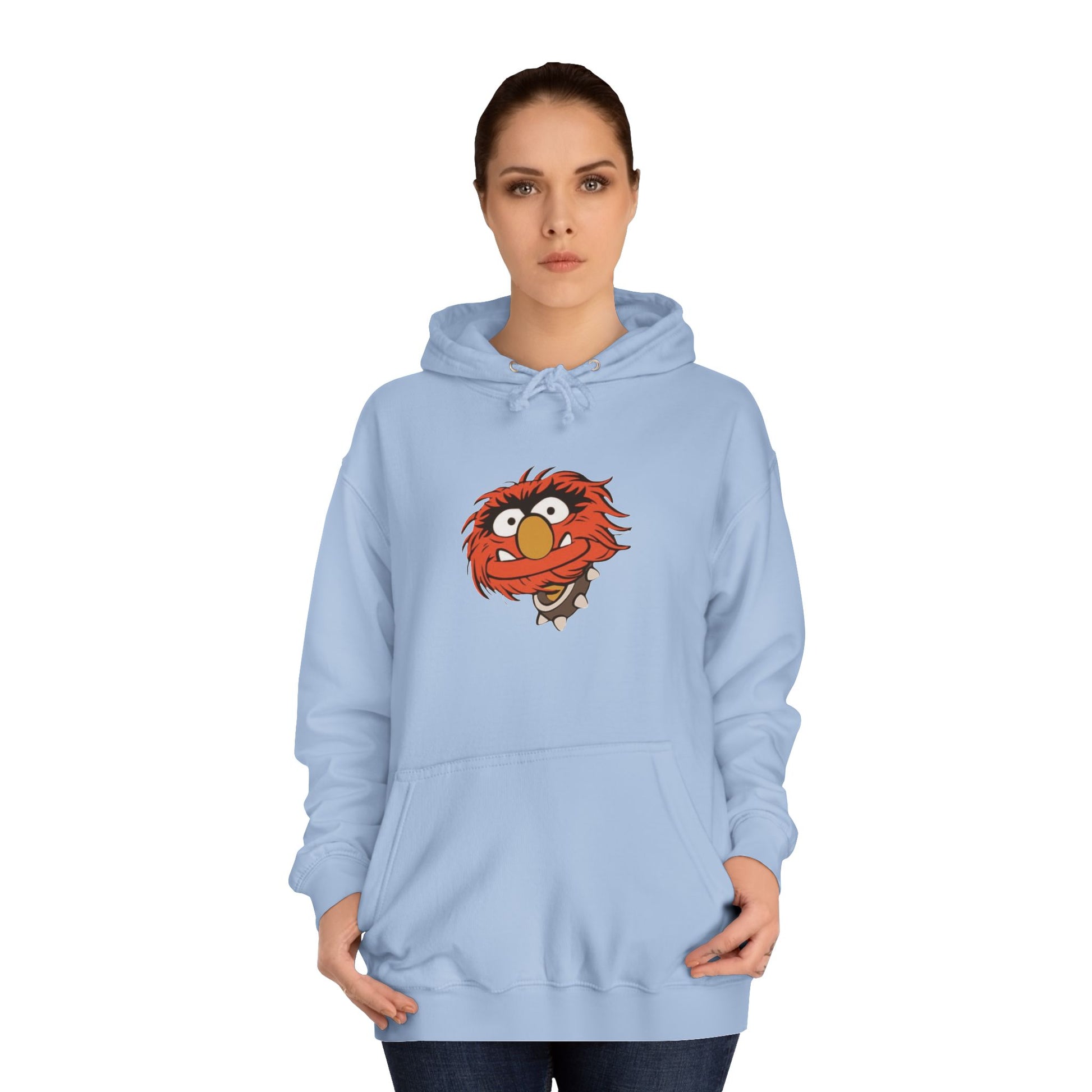 This comfy unisex college hoodie by Printify showcases a vibrant design of a cartoon character with wild orange hair, bulging eyes, and a broad grin on the front, embodying that lively spirit. It's like wearing the Animal - The Muppets hoodie without sacrificing comfort.