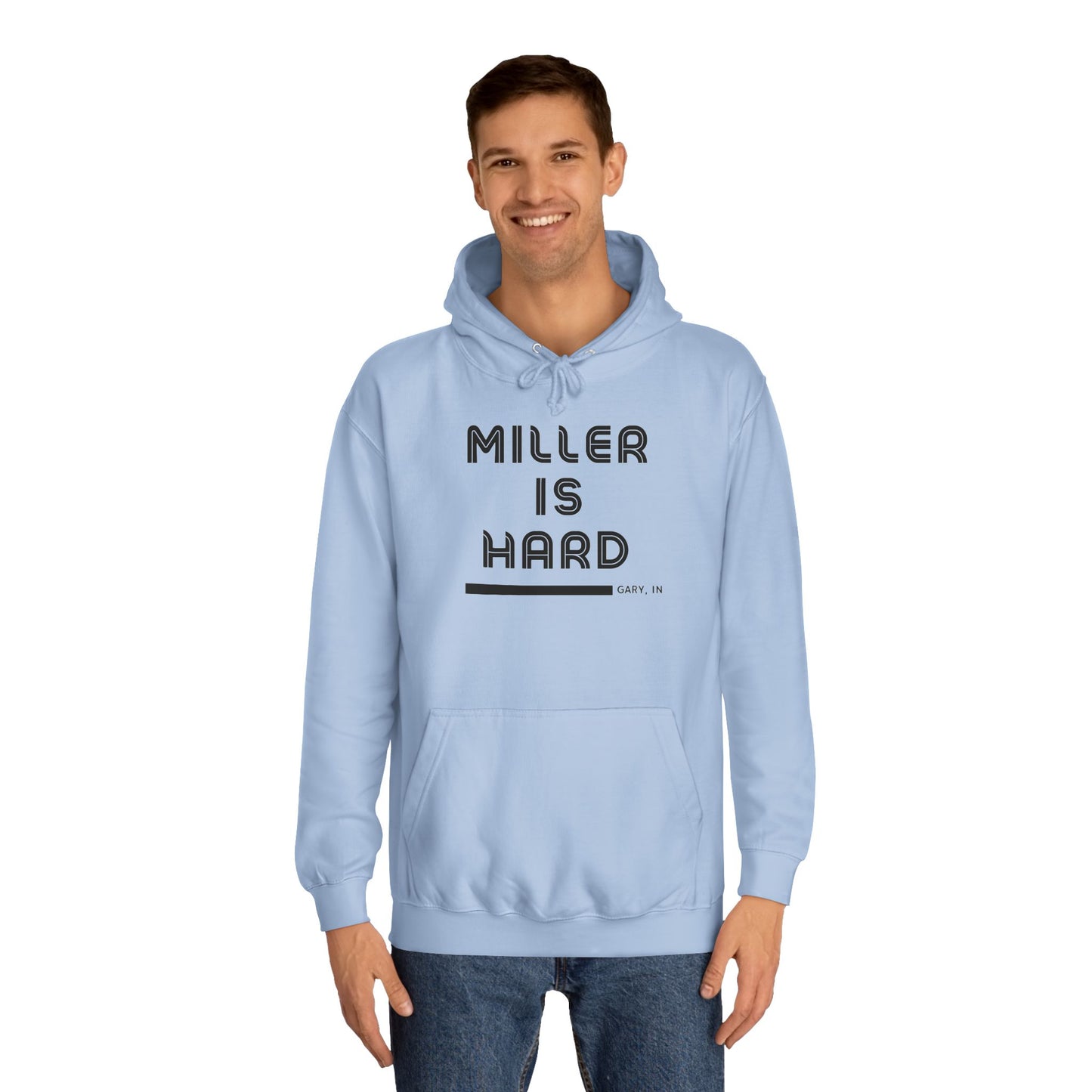 A light blue unisex college hoodie from Printify features the bold black text "MILLER IS HARD" on the front, with "GARY, IN." in smaller letters below. This hoodie is equipped with a front pocket and adjustable drawstrings, ideal for those who appreciate the Miller Beach style.