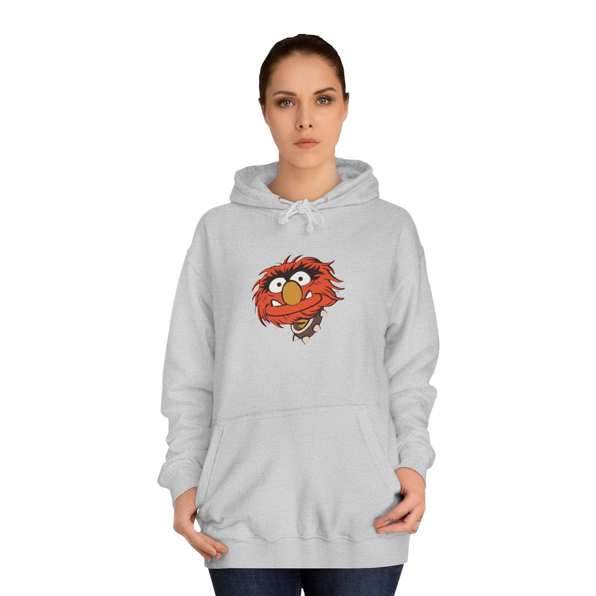 This comfy unisex college hoodie by Printify showcases a vibrant design of a cartoon character with wild orange hair, bulging eyes, and a broad grin on the front, embodying that lively spirit. It's like wearing the Animal - The Muppets hoodie without sacrificing comfort.