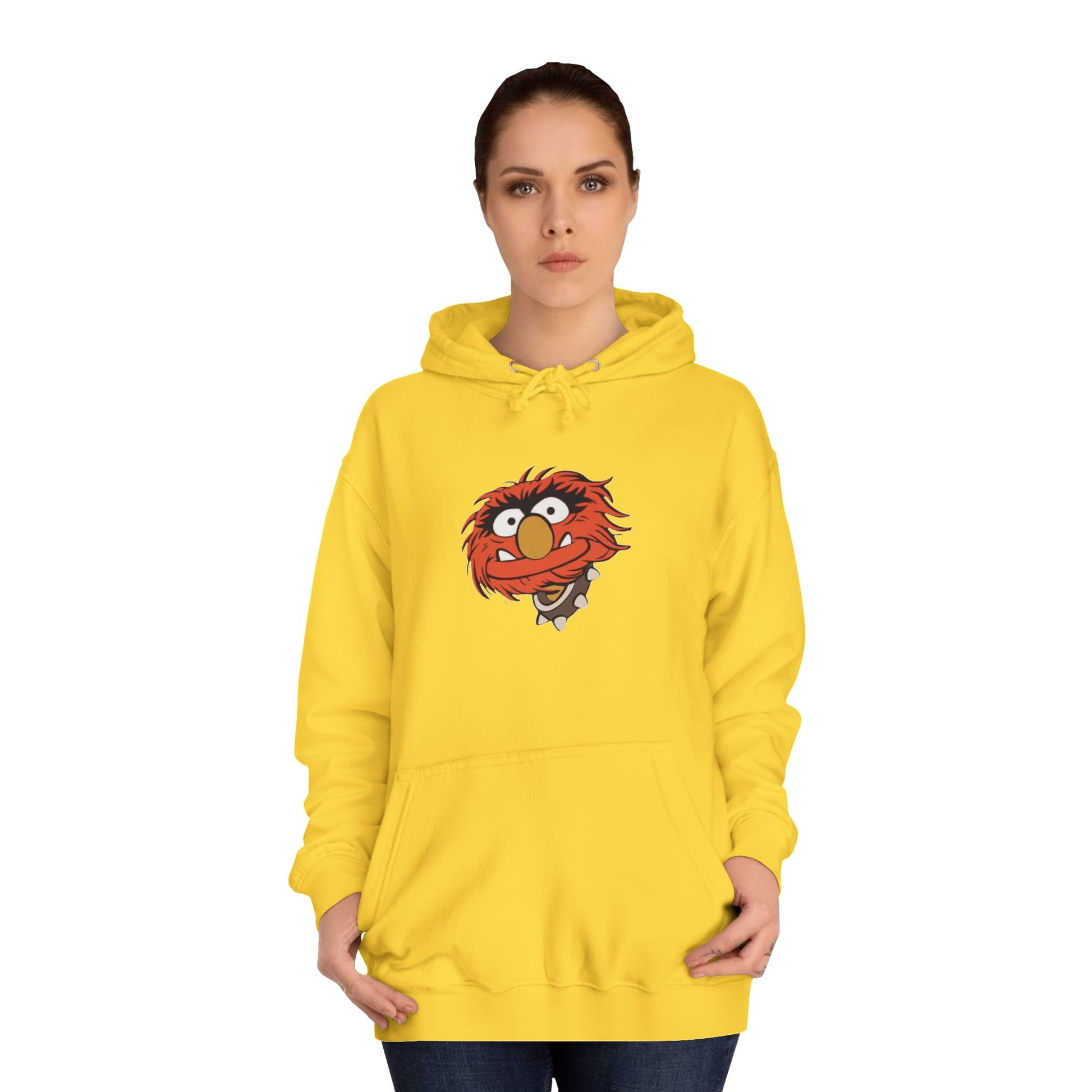 This comfy unisex college hoodie by Printify showcases a vibrant design of a cartoon character with wild orange hair, bulging eyes, and a broad grin on the front, embodying that lively spirit. It's like wearing the Animal - The Muppets hoodie without sacrificing comfort.