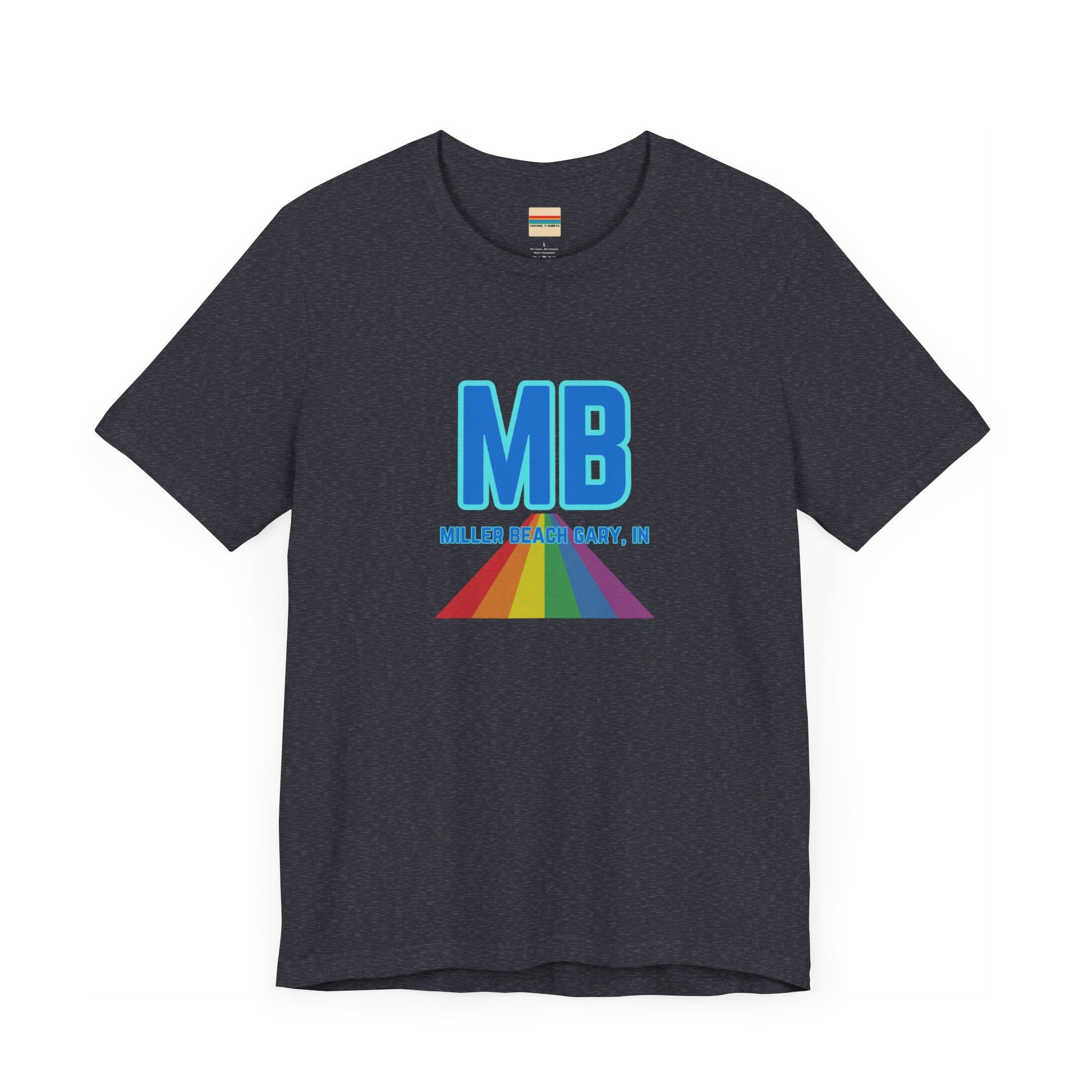 The Miller Beach Pride - Unisex Jersey Short Sleeve Tee by Printify is a white shirt made from 100% Airlume combed cotton. It showcases a design with large, bold blue letters "MB" at the top. Beneath it, the text "MILLER BEACH GARY, IN" is written in blue. A colorful, triangular rainbow graphic extends downward from the text, symbolizing Miller Beach pride.