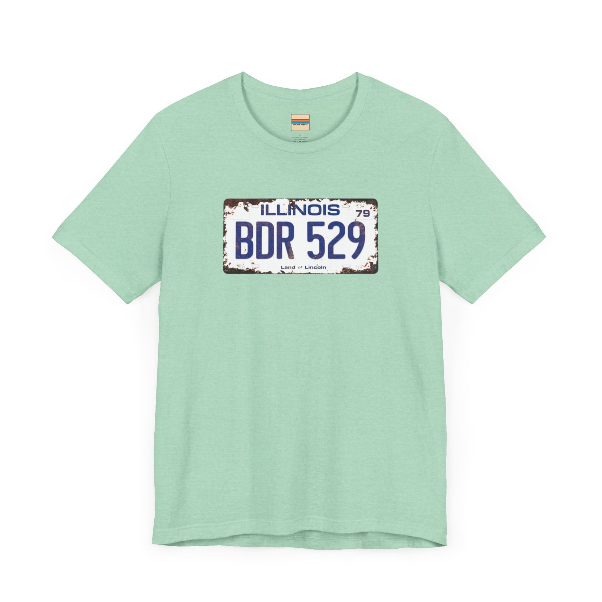 The Printify Blues Brothers BDR 529 License Plate Unisex Jersey Short Sleeve Tee showcases a vintage Illinois license plate graphic with "BDR 529" prominently displayed, as famously seen in the Blues Brothers film. The design includes "Illinois" and "Land of Lincoln" above and below the numbers, with a weathered, rustic look that enhances its retro appeal.