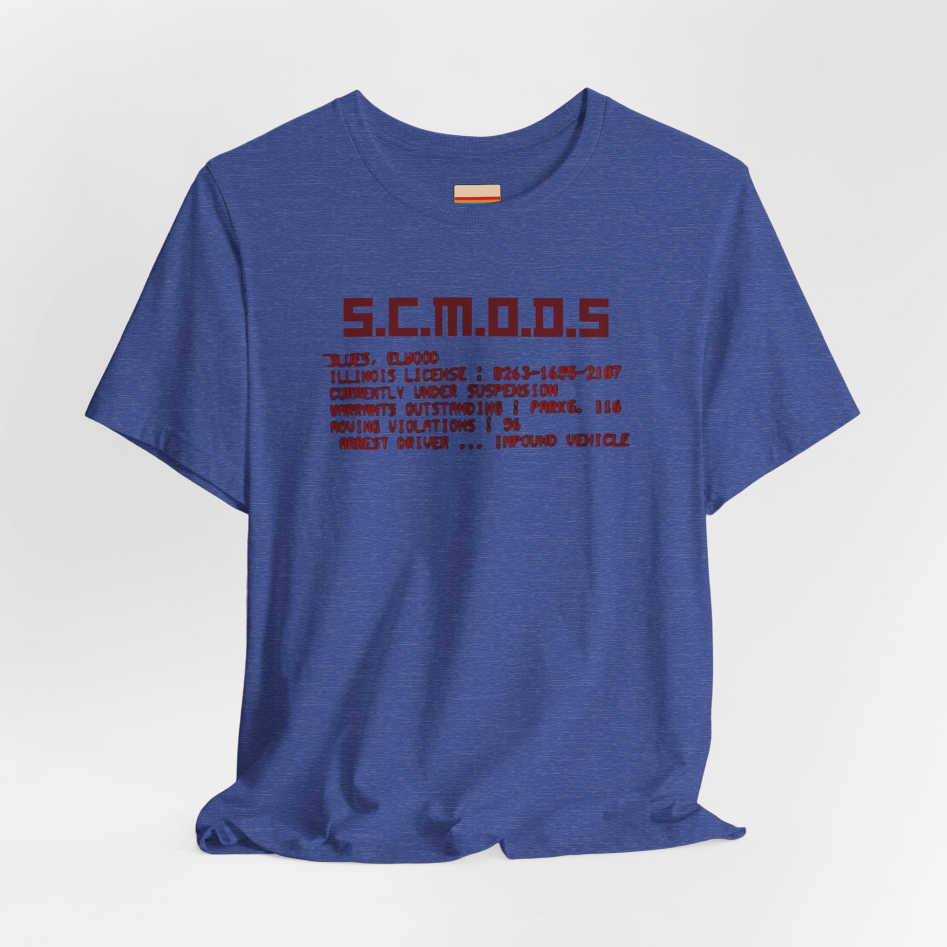 Two yellow "S.C.M.O.D.S. Blues Brother's - Unisex Jersey Short Sleeve Tee" shirts from Printify, featuring "S.C.M.O.D.S" in bold, stylized letters along with smaller text detailing terms like "Illinois," "license," and "impound vehicle." Perfect for fans of The Blues Brothers and Jake and Elwood Blues, the T-shirts are neatly folded and stacked.