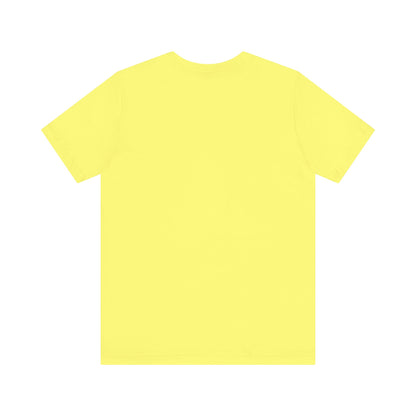 A light blue Printify "The Tinder Box 1980s" unisex jersey short sleeve tee featuring the "Tinder Box" logo in the center. The logo consists of a dark shield with the words "Tinder Box" in white text, with a small flame icon replacing the dot above the "i".