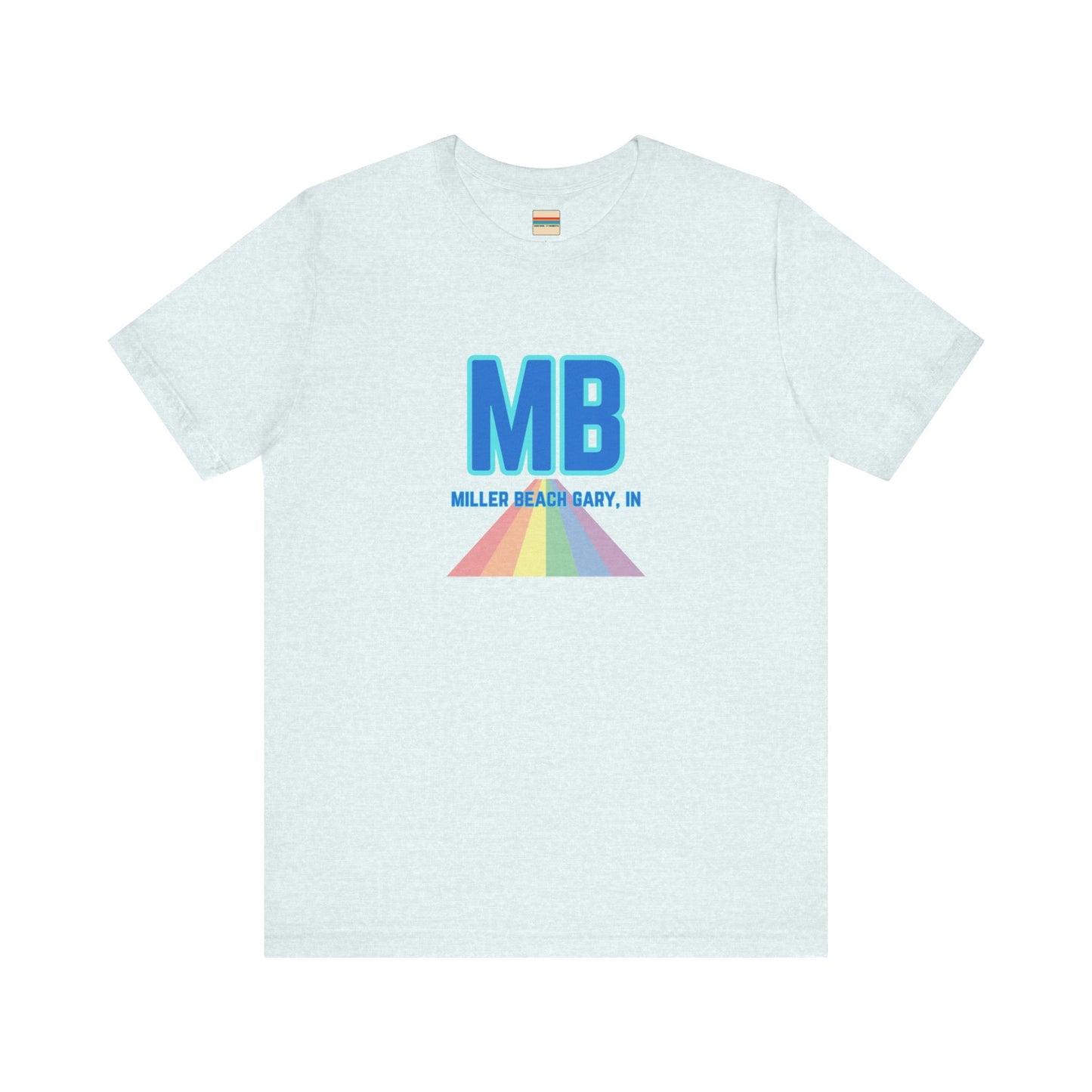 The Miller Beach Pride - Unisex Jersey Short Sleeve Tee by Printify is a white shirt made from 100% Airlume combed cotton. It showcases a design with large, bold blue letters "MB" at the top. Beneath it, the text "MILLER BEACH GARY, IN" is written in blue. A colorful, triangular rainbow graphic extends downward from the text, symbolizing Miller Beach pride.