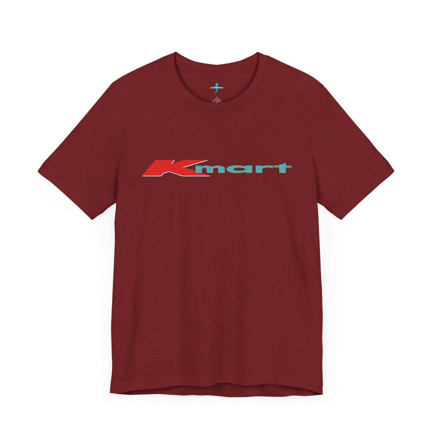 The Printify KMart Logo 1980s Retro - Unisex Jersey Short Sleeve Tee in dark gray features a nostalgic design with the iconic logo in red and teal across the chest. This short-sleeve crew-neck shirt exudes vintage charm with its simple, classic look.