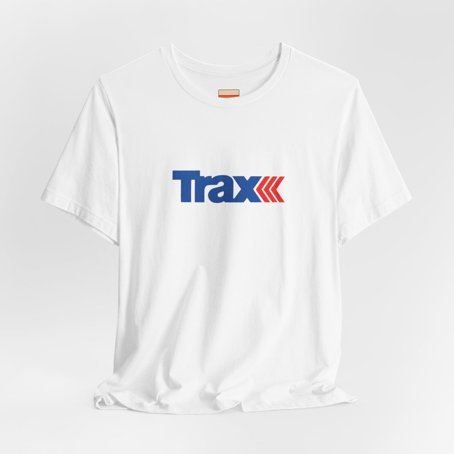 A gray unisex jersey short sleeve tee from Printify, inspired by retro 1980s Kmart style. The "Trax" logo is printed in blue letters, followed by three red arrows pointing to the right. This classic Trax Brand T-shirt is laid flat against a white background, capturing nostalgic fashion vibes.