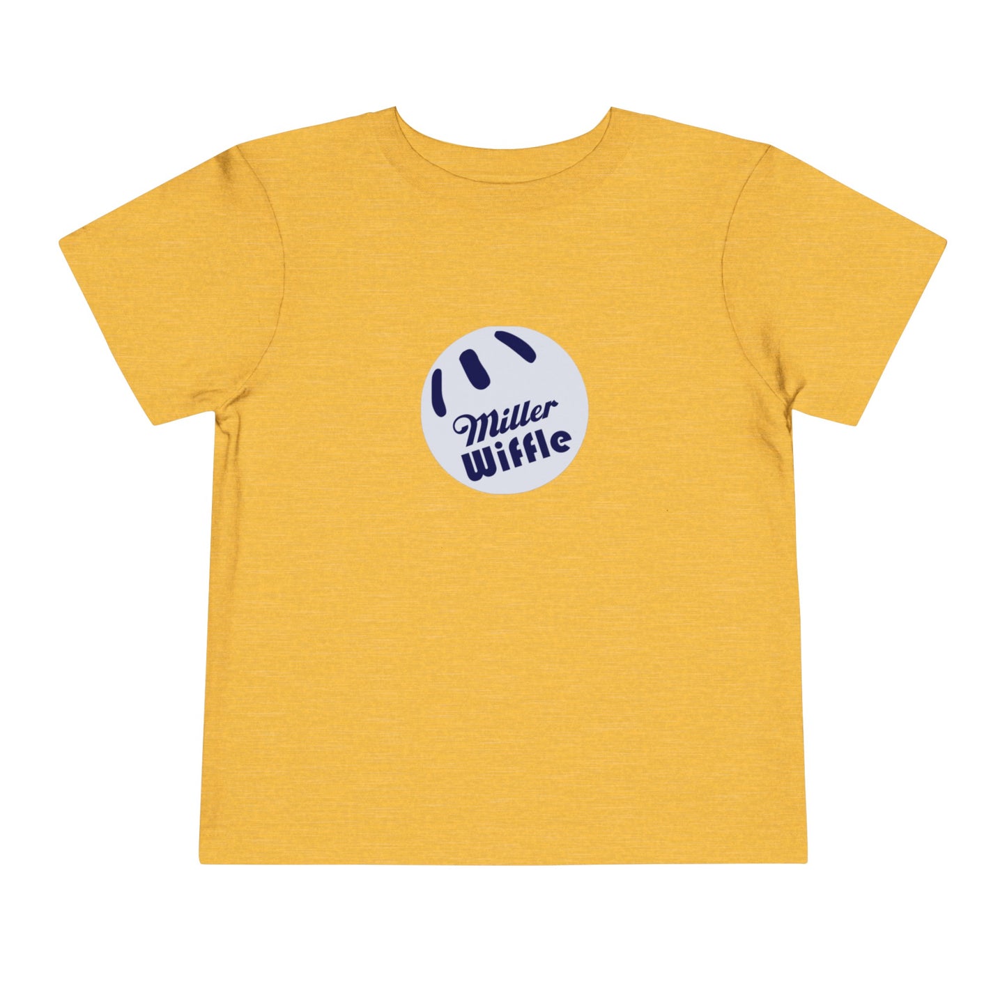 A young child with light hair stands against a plain white background, smiling while wearing a vibrant yellow Printify short sleeve tee named "Miller Wiffel Ball OG Logo - Toddler Short Sleeve Tee." The shirt features the "Miller Wiffle" text and a wiffle ball graphic on the front. The child is also dressed in blue pants.