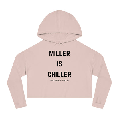 A white Women's Cropped Hooded Sweatshirt by Printify, featuring the phrase "MILLER IS CHILLER" printed in bold black letters on the front. Below the phrase, it says "MILLER BEACH • GARY, IN" in smaller black text. The SoCool Shirts hoodie includes a drawstring hood and long sleeves.