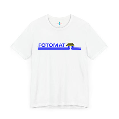 The Fotomat 1970s Retro T-Shirt by Printify is a dark gray short-sleeve shirt that features the word "FOTOMAT" in bold blue capital letters and a blue and yellow graphic design resembling layered lines and an upside-down triangle. This Tshirt captures the essence of 80s nostalgia with its centered, retro design.