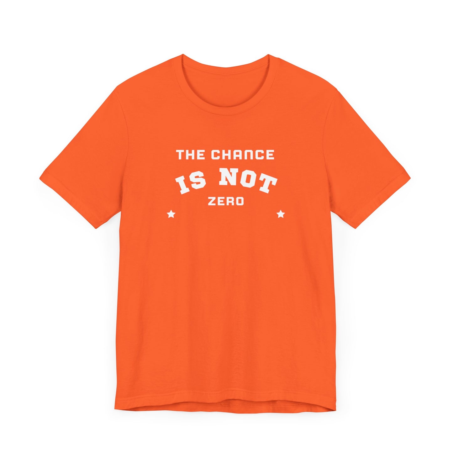 Folded light red Unisex Jersey Short Sleeve Tee from Printify, featuring bold white text that reads "THE CHANCE IS NOT ZERO" along with two star illustrations. This motivational T-shirt, made from breathable fabric, is neatly stacked with another identical shirt underneath.