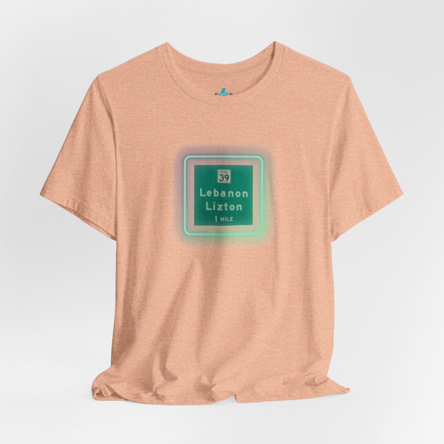 Introducing "The Lebanon Loop - Indiana" unisex jersey short sleeve tee by Printify. This green t-shirt features a graphic of a road sign displaying "39 Lebanon Lizton 1 MILE" within a slightly glowing square frame. It's crafted from 100% Airlume cotton and photographed flat on a white background.