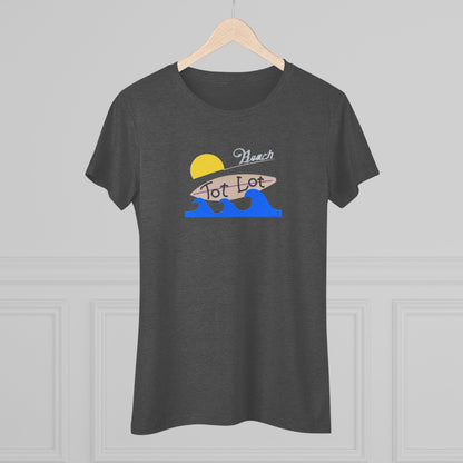 Introducing the Tot Lot Full Sign - Miller Beach - Women's Triblend Tee by Printify! This stylish gray t-shirt features a vintage-inspired design showcasing a setting sun, a surging blue wave, and the phrase "Miller Beach Tot Lot" in eye-catching stylized fonts. Perfect for any casual outing, this beach-themed top exudes a playful and trendy vibe.