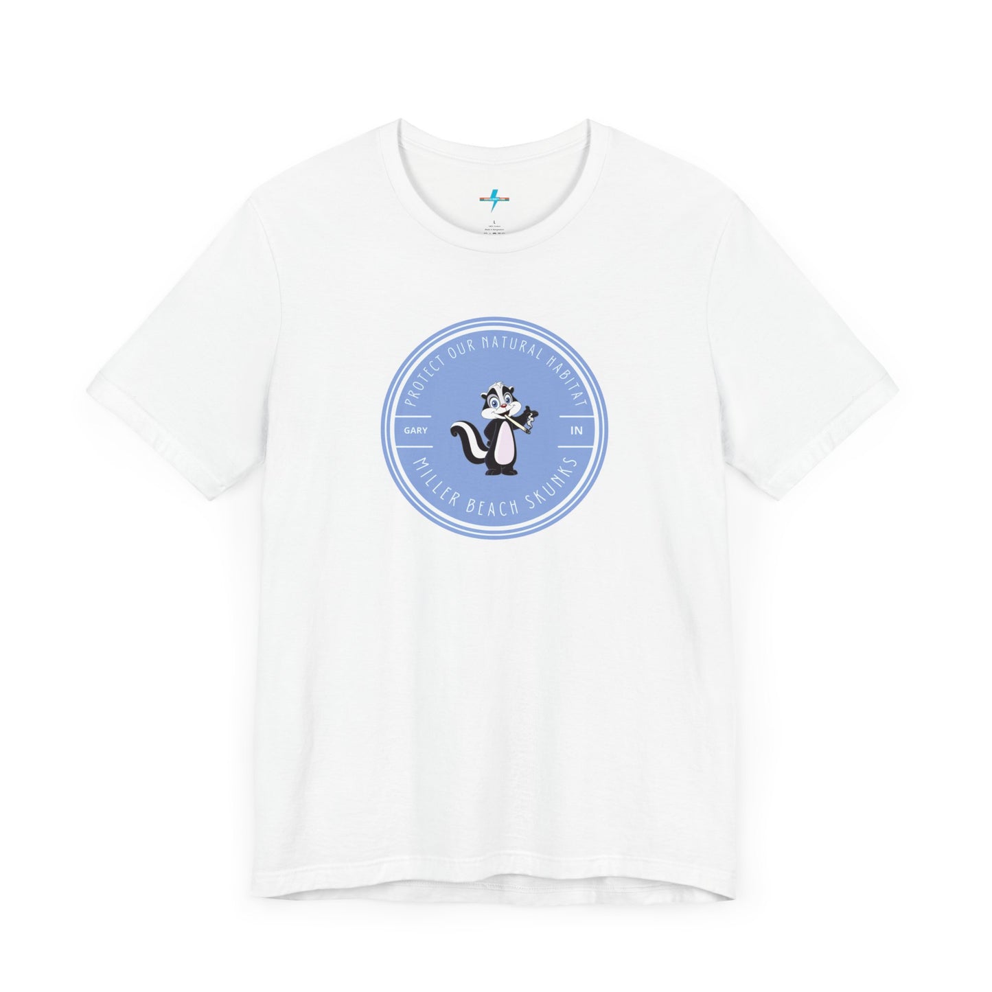 The Printify Miller Beach Skunks - Unisex Jersey Short Sleeve Tee is a gray T-shirt that features a circular blue logo at the center. Inside the logo, there is an illustration of a skunk with the text "Protect Our Habitat" and "Miller Beach Skunks" around the border, promoting environmental consciousness. The upper left part of the logo reads "Gary, IN.