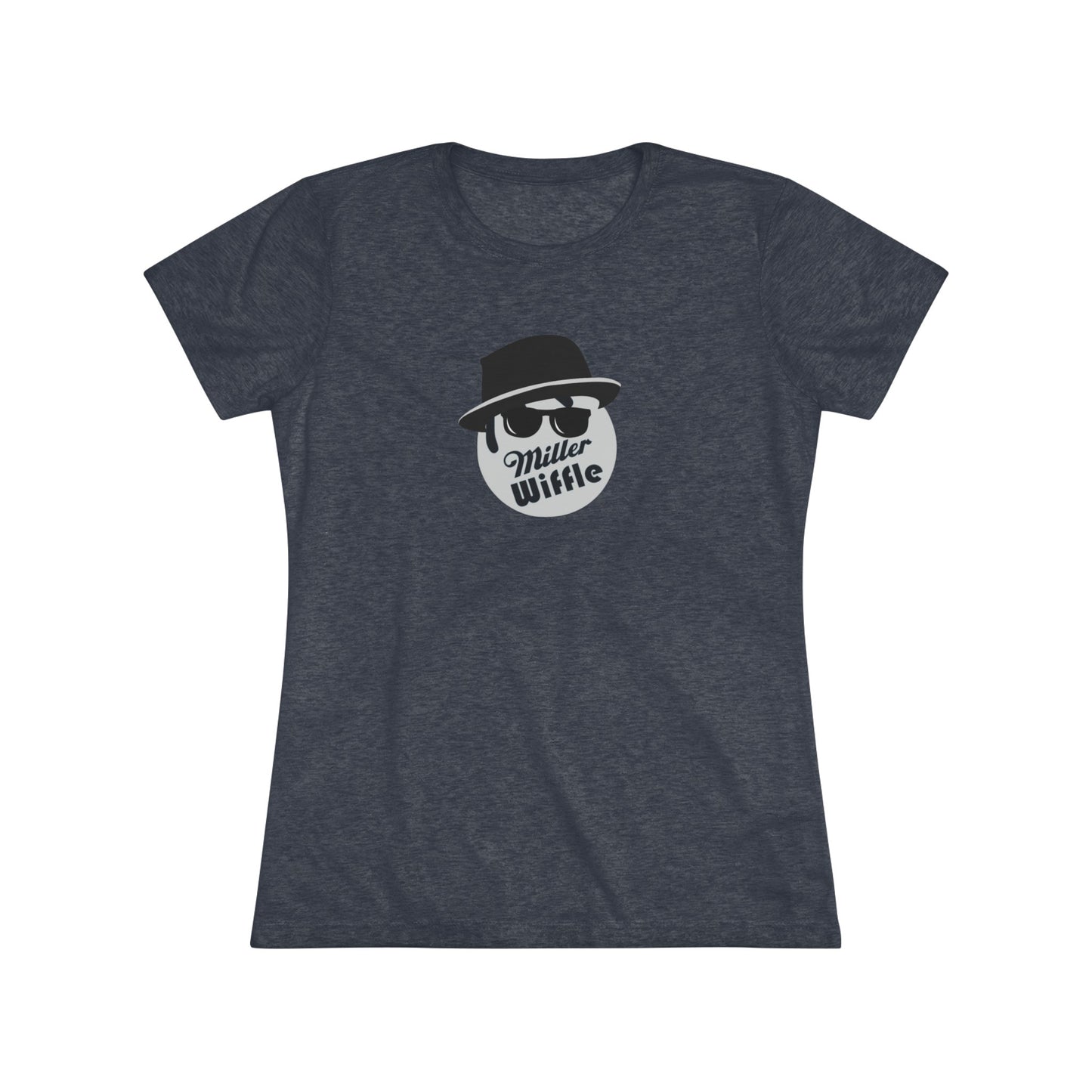 A cozy red t-shirt, the Miller Wiffel Ball - Blues Brothers - Women's Triblend Tee by Printify, features a graphic of a masked face wearing a fedora hat and sunglasses, along with the text "Miller Wiffle." The t-shirt is displayed on a wooden floor, paired with a denim jacket, white sneakers, and a potted green plant to create a vintage look.