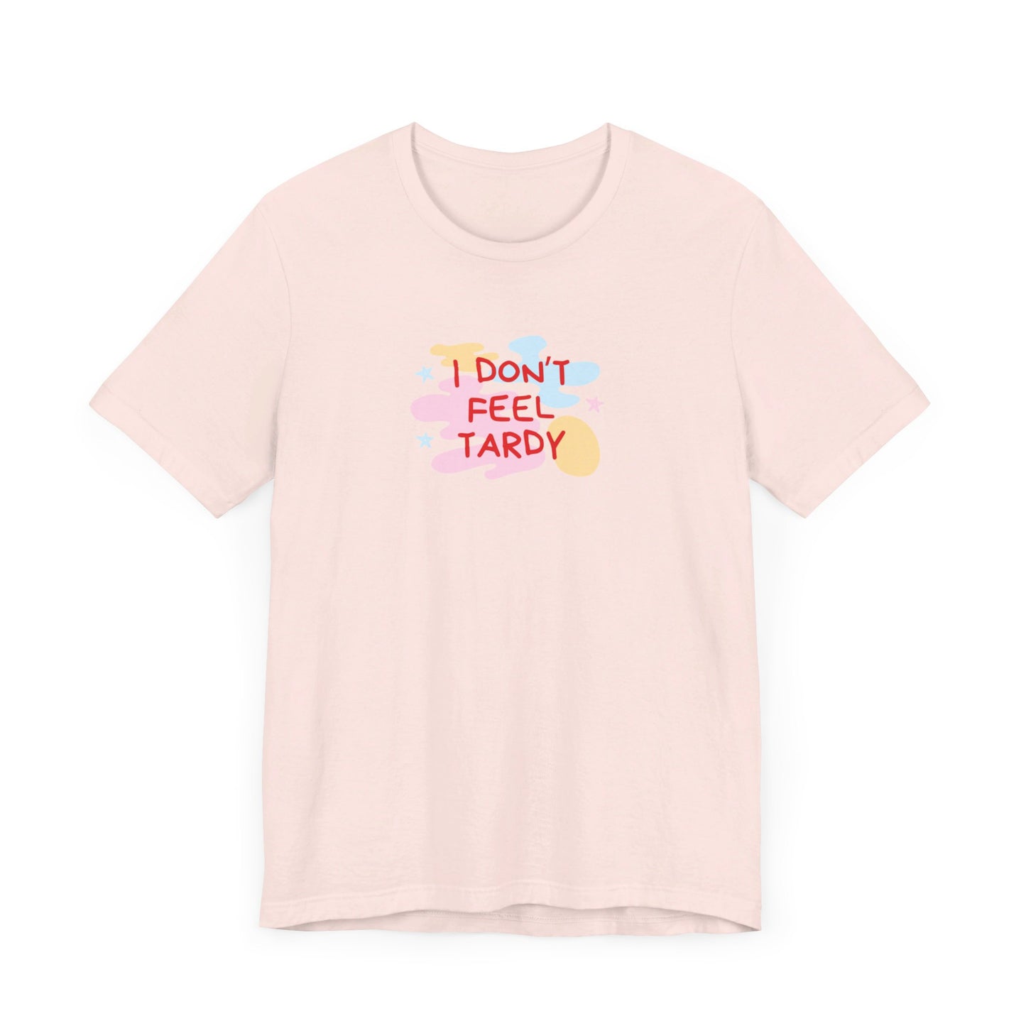 The "I Don't Feel Tardy - 1980s Retro - Unisex Jersey Short Sleeve Tee" from Printify is a light pink jersey shirt that features the bold, colorful text "I DON'T FEEL TARDY" prominently at its center. This design exudes retro vibes with small star shapes and abstract splashes of blue, yellow, and pink, laid flat against a plain background to channel pure Van Halen T-shirt energy.