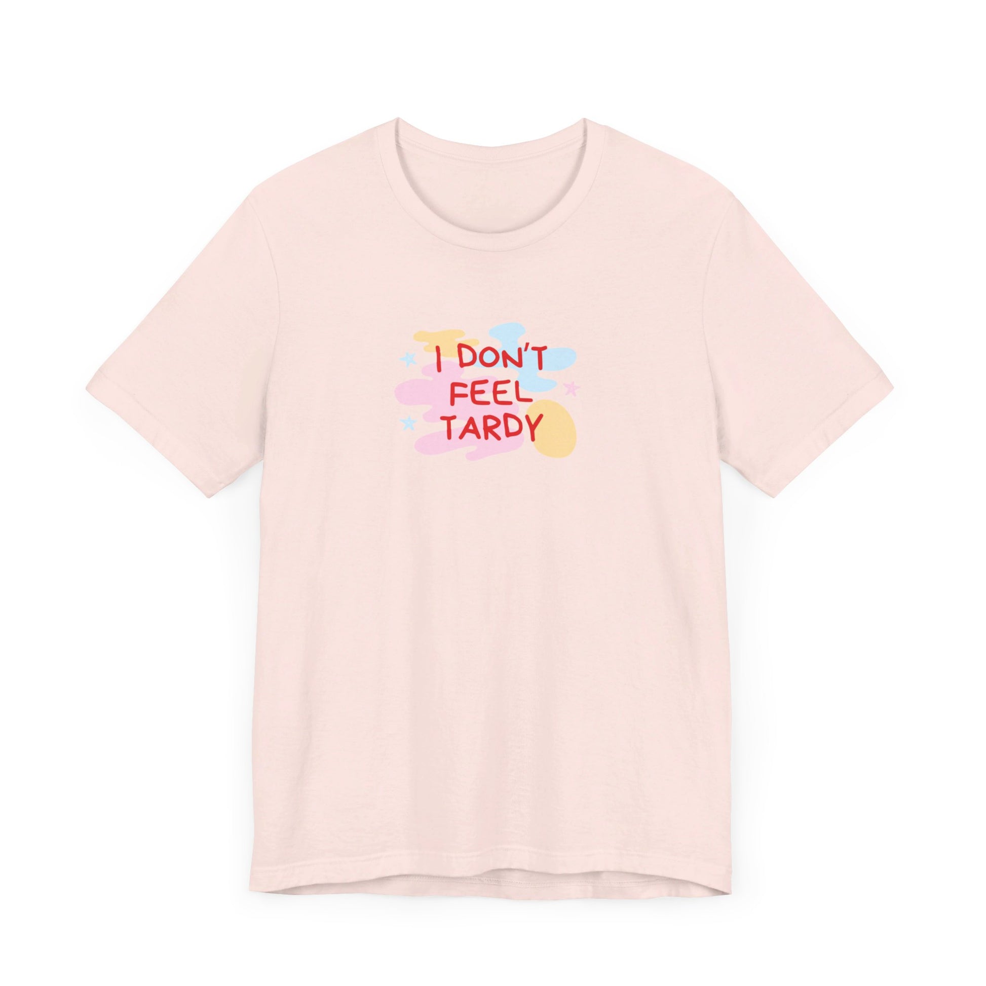 The "I Don't Feel Tardy - 1980s Retro - Unisex Jersey Short Sleeve Tee" from Printify is a light pink jersey shirt that features the bold, colorful text "I DON'T FEEL TARDY" prominently at its center. This design exudes retro vibes with small star shapes and abstract splashes of blue, yellow, and pink, laid flat against a plain background to channel pure Van Halen T-shirt energy.