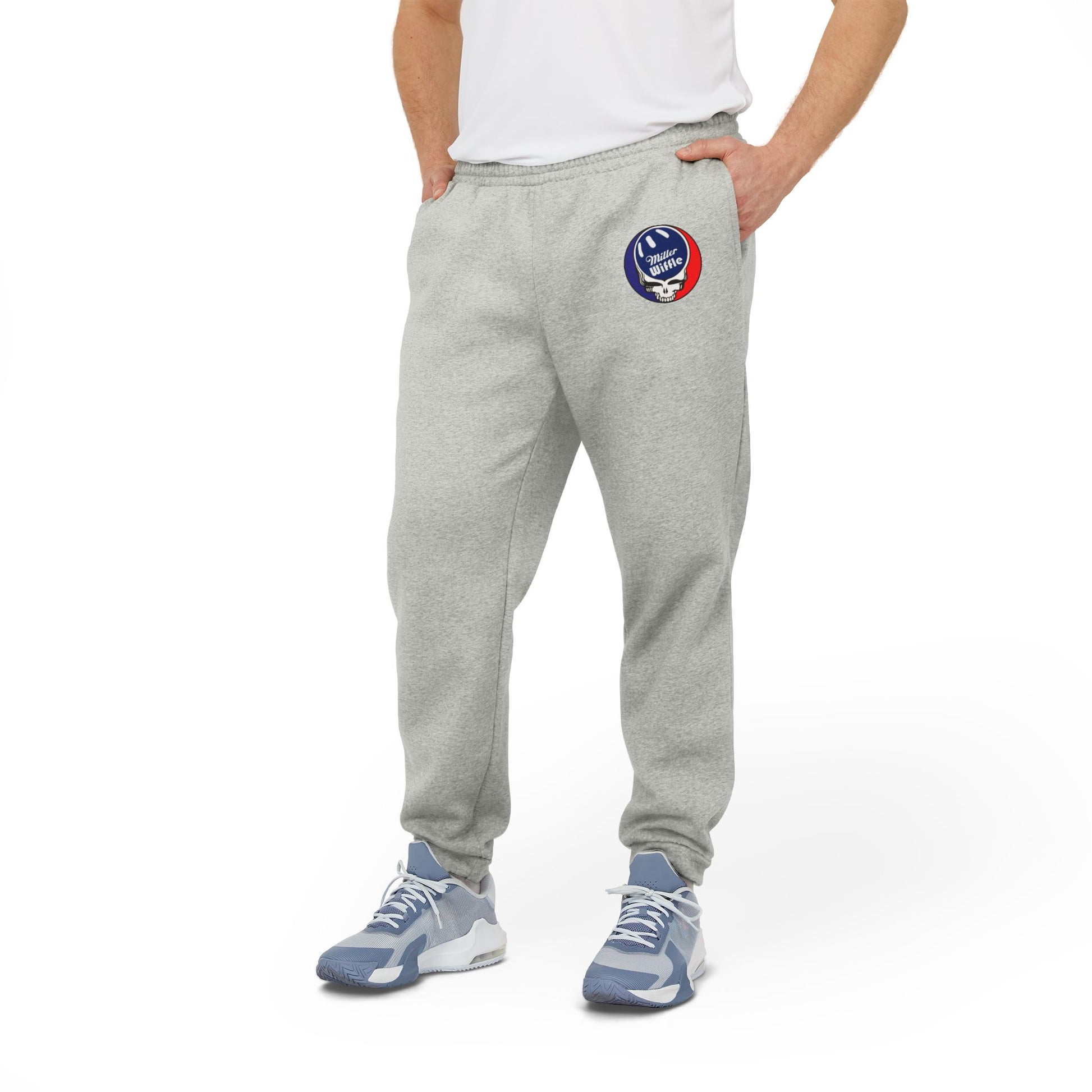 Adidas Unisex Fleece Joggers from Printify, featuring a gray design with an embroidered basketball and hoop logo on the upper left leg, made from sustainable materials for ultimate comfort and style.