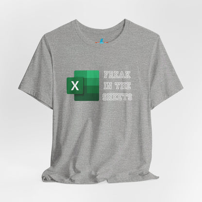 A green Freak in the Sheets - Excel - Unisex Jersey Short Sleeve Tee from Printify, featuring the Microsoft Excel logo on the left. The text next to the logo reads, "FREAK IN THE SHEETS" in white, bold, all-caps letters, making it perfect for spreadsheet enthusiasts. The shirt is laid flat against a plain white background.