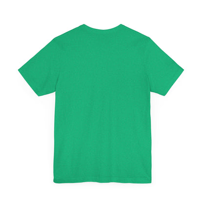 A light blue Printify "The Tinder Box 1980s" unisex jersey short sleeve tee featuring the "Tinder Box" logo in the center. The logo consists of a dark shield with the words "Tinder Box" in white text, with a small flame icon replacing the dot above the "i".