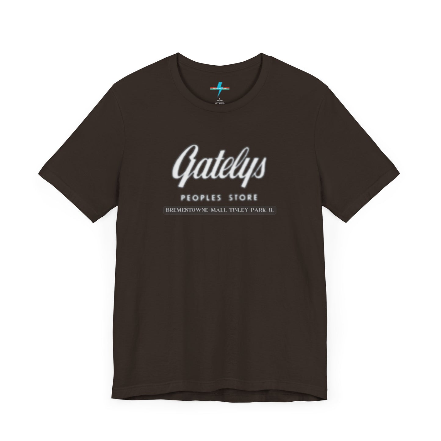 A green unisex jersey short sleeve tee from Printify's SoCool Shirts collection, featuring "Gately's People's Store" printed prominently in white on the front. Below this, smaller text reads "Tinley Park's Brementowne Mall" in white. The T-shirt is displayed against a plain white background and is named the "Gatelys Peoples Store - Vintage 1980s.