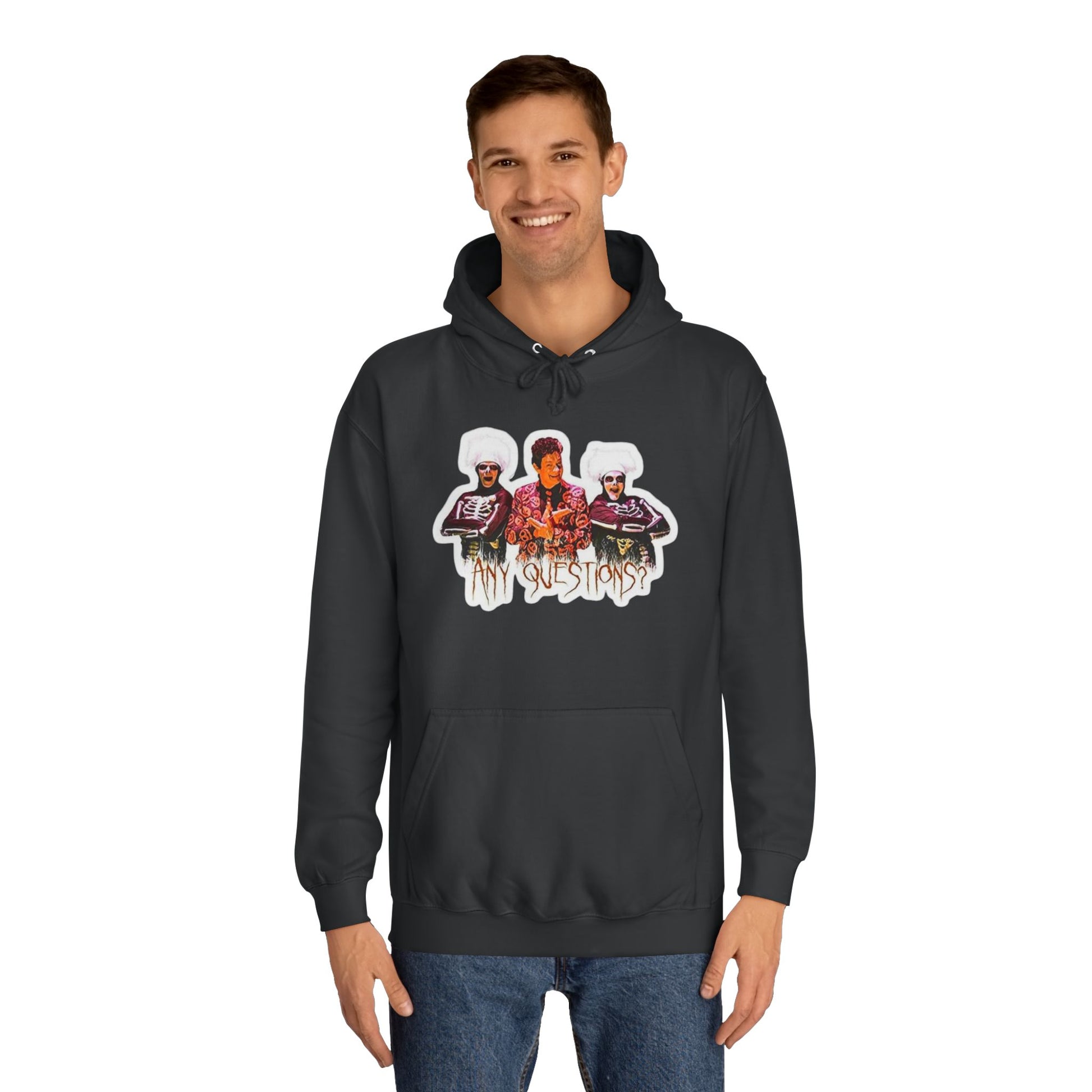 The David S Pumpkins - Any Questions? - Halloween Unisex College Hoodie by Printify is a brown sweatshirt showcasing an illustration of three people. The central figure has red hair, sports a colorful ensemble, and emanates a Halloween vibe, with two flanking figures who have white hair and wear dark attire. Beneath the trio is the phrase "Any Questions?