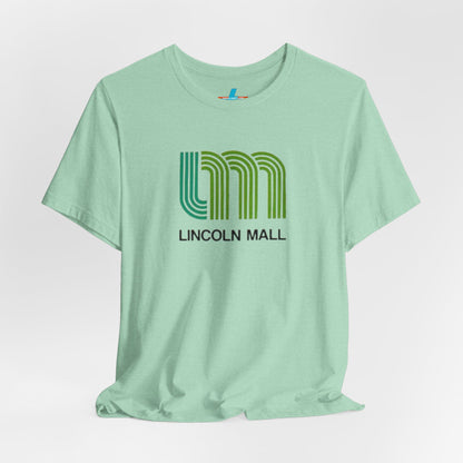 A light green unisex jersey short sleeve tee by Printify features "LINCOLN MALL" written under a retro-styled green and blue curved line design, celebrating the 70s and 80s shopping era in Lincoln Mall Matteson.