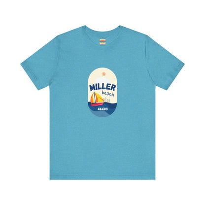 The Miller Beach Sailboat - Unisex Jersey Short Sleeve Tee by Printify features a vibrant graphic design portraying a sailboat on water with a sun above it and the text "MILLER beach 46403." This white retail fit shirt is crafted from soft Airlume combed cotton and showcases rounded graphics in blue, orange, and yellow.