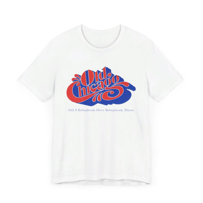 The "Old Chicago Mall Bolingbrook 1980s Retro - Unisex Jersey Short Sleeve Tee" from Printify is a gray T-shirt showcasing a vintage design with the text "Old Chicago" in blue and red. Beneath the main text, the address "355 S. Bolingbrook Drive, Bolingbrook, Illinois" appears in smaller font, evoking 80s nostalgia of the Old Chicago Mall. The shirt is displayed against a white background.