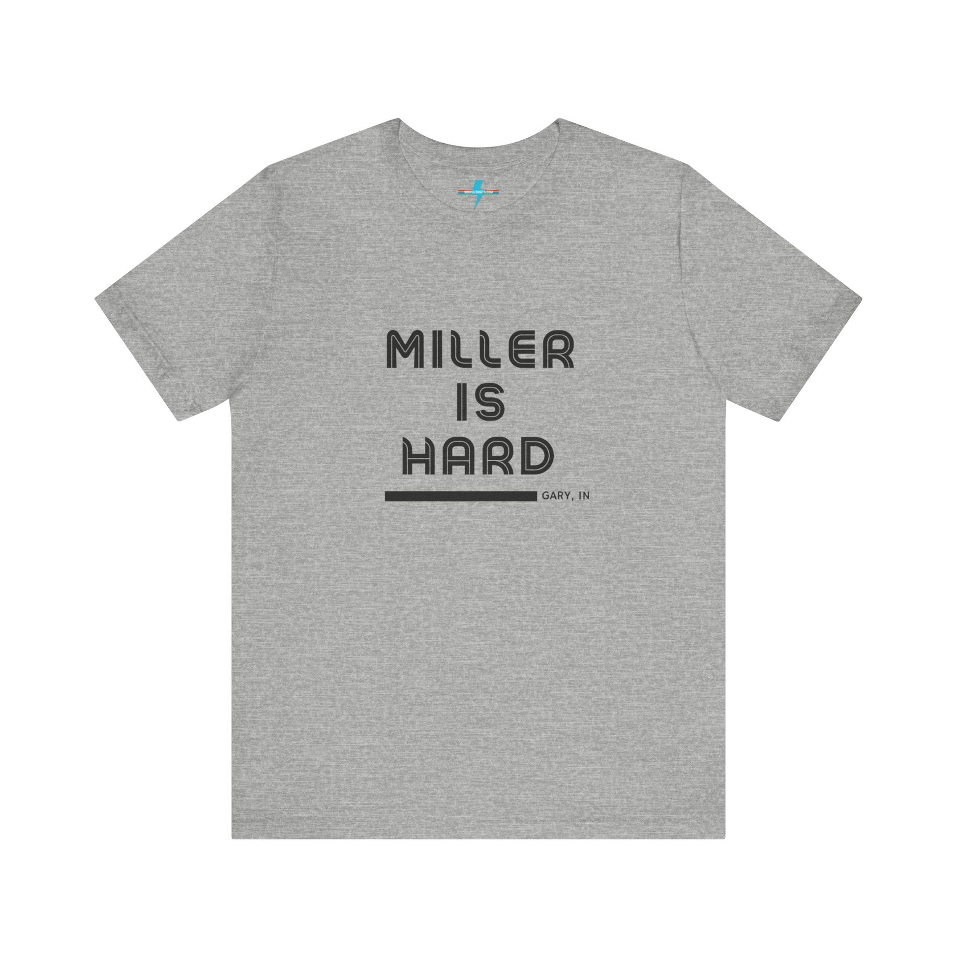 A unisex jersey short sleeve tee from Printify in burnt orange features the bold black text "MILLER IS HARD" on the chest, with "GARY, IN" written beneath in smaller black font. Perfect for showcasing Miller Beach's iconic spirit, this t-shirt is displayed against a plain white background.