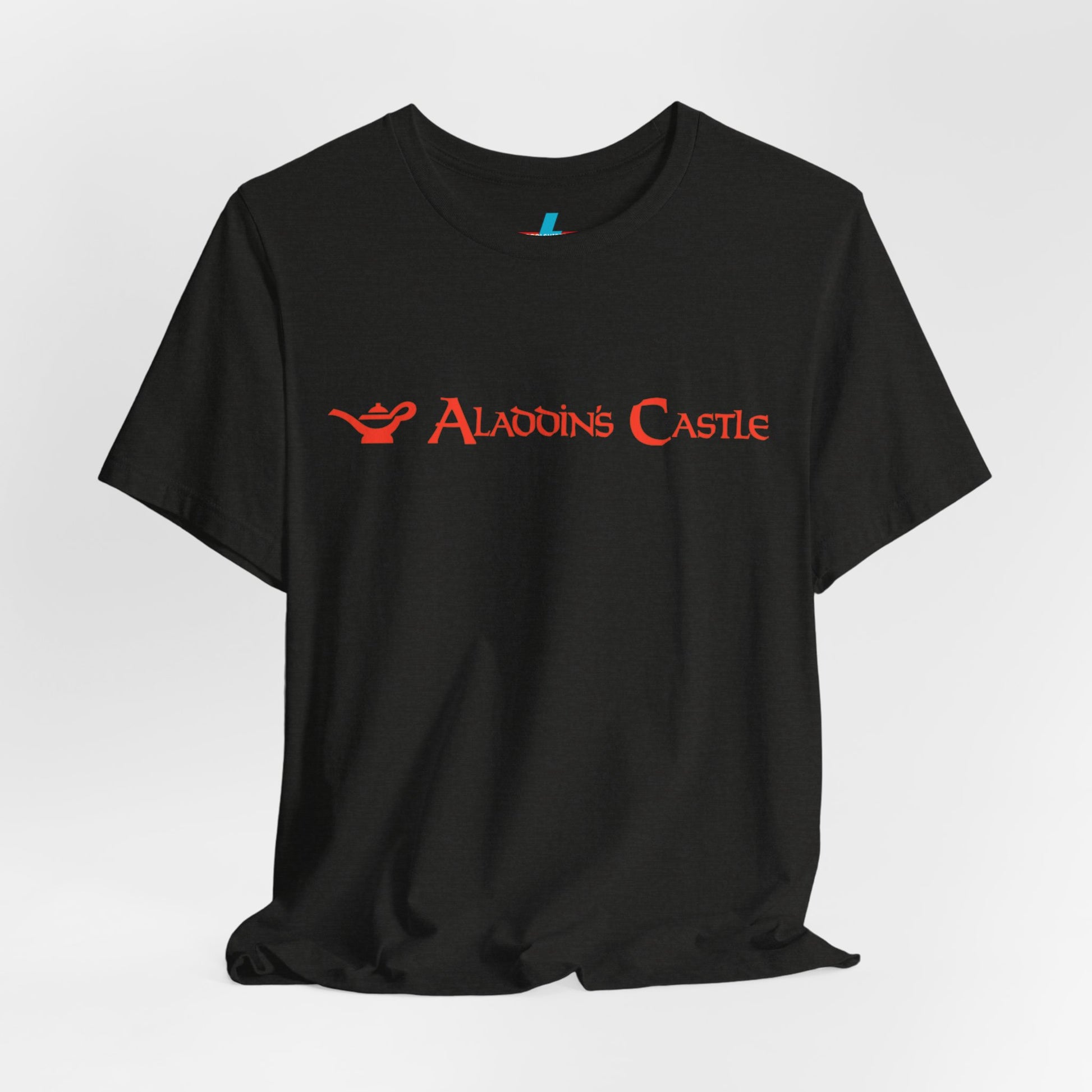 Introducing the Aladdin's Castle Arcade 1980s Unisex Jersey Short Sleeve Tee by Printify. This dark grey heather T-shirt features "ALADDIN'S CASTLE" emblazoned in bright red font across the chest, with a small silhouette of Aladdin's magic lamp to the left of the text. Perfect for fans of retro design or Aladdin’s Castle Arcade, and available exclusively from SoCool Shirts.