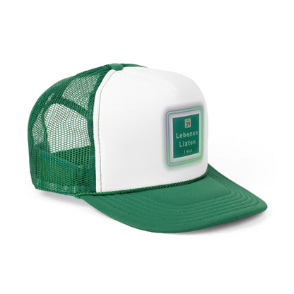 The Printify "The Lebanon Loop - Indiana" trucker cap features a green brim, mesh back, and an adjustable plastic snap closure. It showcases a blurred print of a highway sign that reads "39 Lebanon Lizton 1 mi" in white text on a green background, making it the perfect addition to your collection.