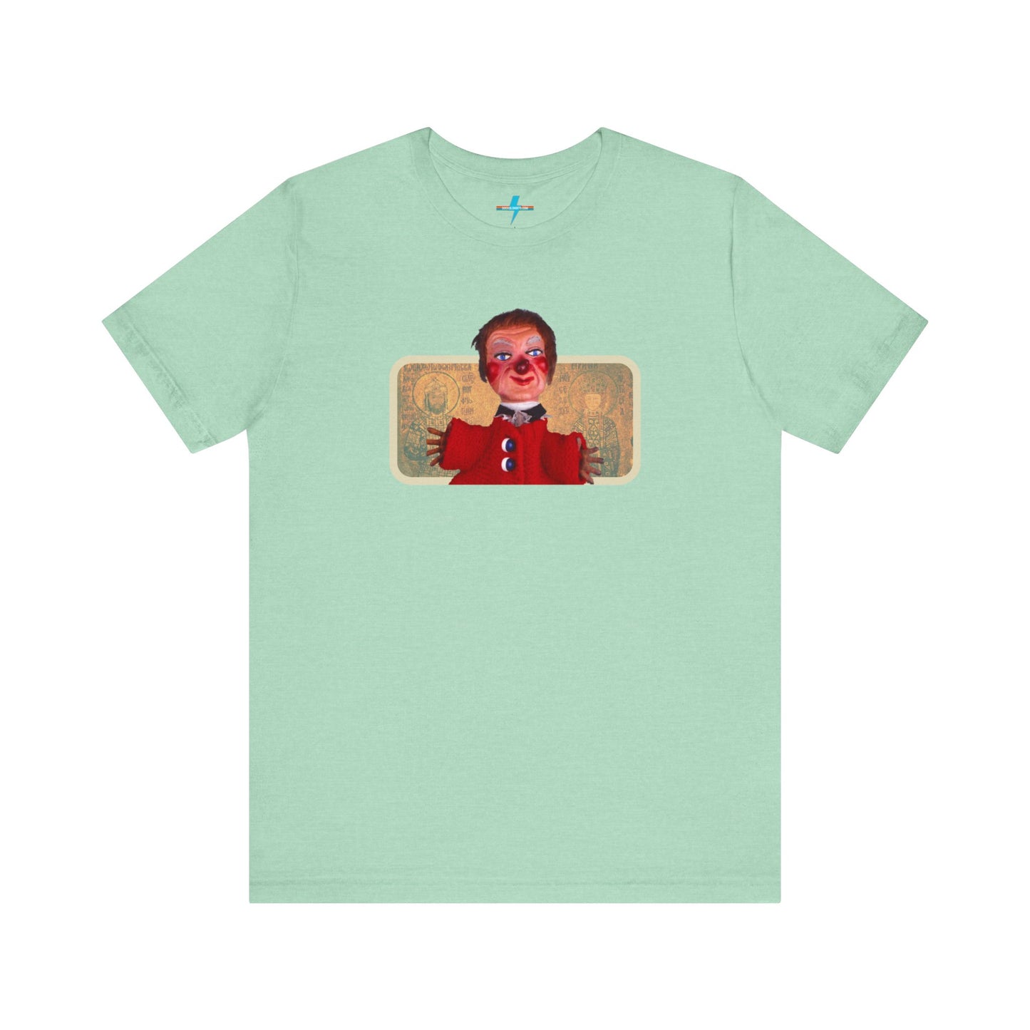 The rust-colored Printify Lady Elaine - Mr. Rogers Unisex Jersey Short Sleeve Tee features a detailed image of the Lady Elaine puppet, dressed in a red outfit with a painted face, set against an intricate artistic backdrop. The centrally positioned puppet and vivid colors create a striking contrast against the muted tone of the shirt, evoking nostalgic memories of Mr. Rogers' Neighborhood.