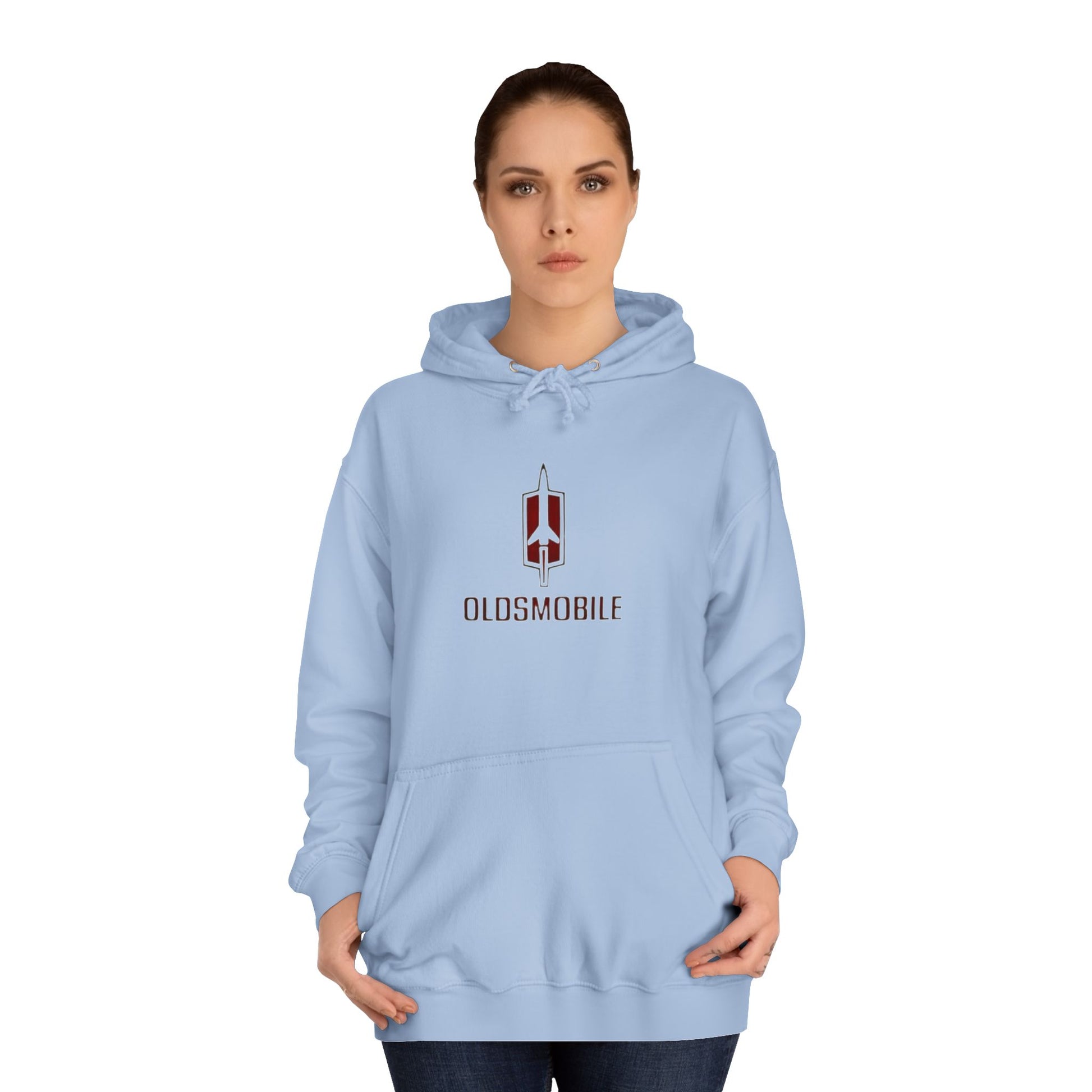 The Oldsmobile 1970s Logo - Unisex College Hoodie by Printify offers a cozy fit in white, featuring a red and black Oldsmobile logo on the front with a stylized rocket above "OLDSMOBILE." It includes a kangaroo pocket and drawstring hood for classic comfort.