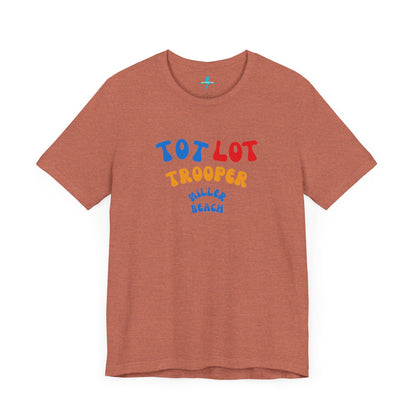 A green unisex jersey short sleeve tee from Printify, featuring colorful text on the front that reads "TOT LOT TROOPER MILLER BEACH" in blue, red, yellow, and orange letters. The shirt is displayed against a plain white background.