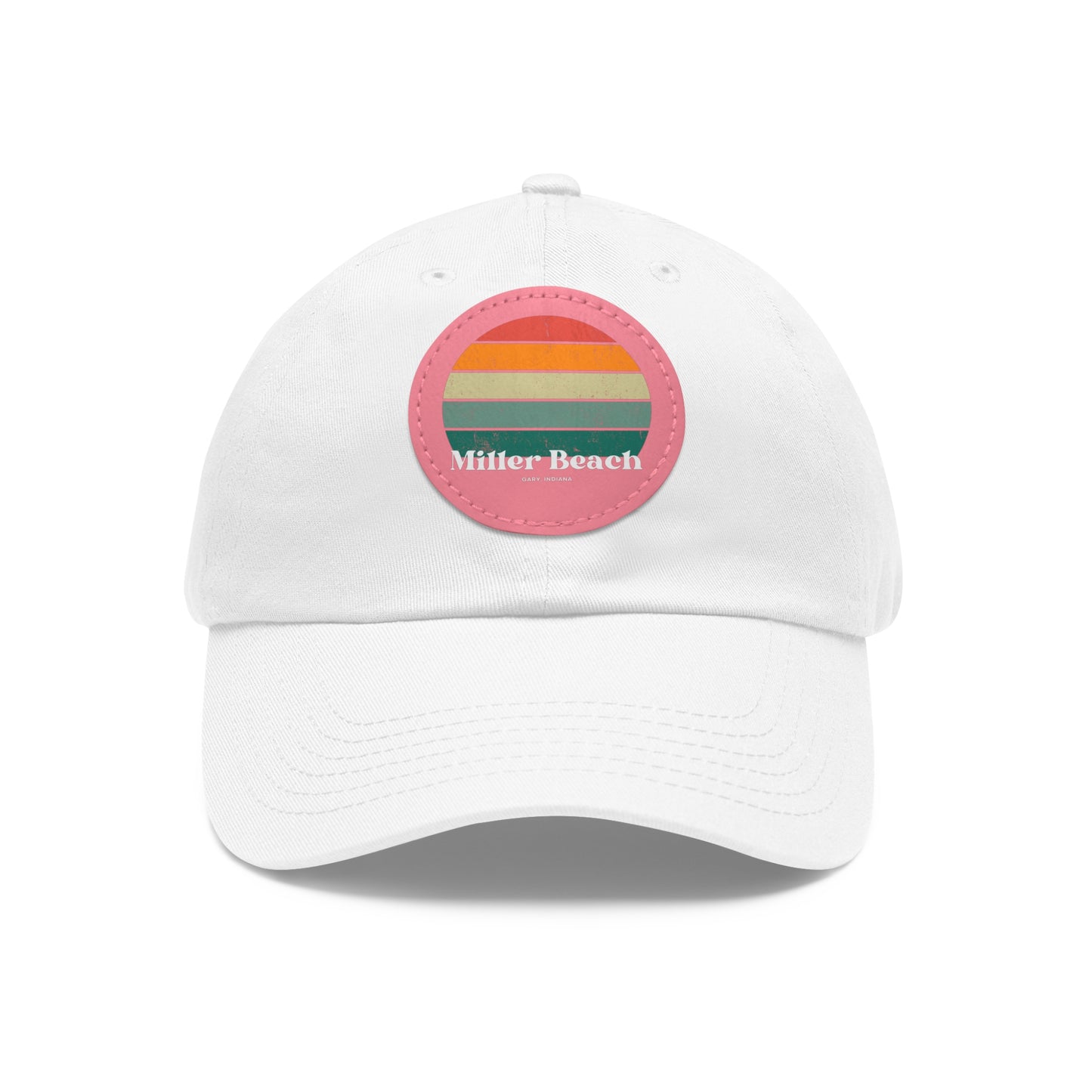 The Miller Beach Retro Sunset - Dad Hat with Leather Patch (Round) by Printify is a pink baseball cap crafted from bio-washed chino twill for added comfort. It features a PU leather patch adorned with horizontal stripes in red, orange, yellow, green, and blue. Below the stripes, "Miller Beach" is embroidered in white. An adjustable strap at the back ensures a perfect fit.