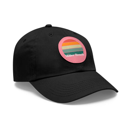 The Miller Beach Retro Sunset - Dad Hat with Leather Patch (Round) by Printify is a pink baseball cap crafted from bio-washed chino twill for added comfort. It features a PU leather patch adorned with horizontal stripes in red, orange, yellow, green, and blue. Below the stripes, "Miller Beach" is embroidered in white. An adjustable strap at the back ensures a perfect fit.