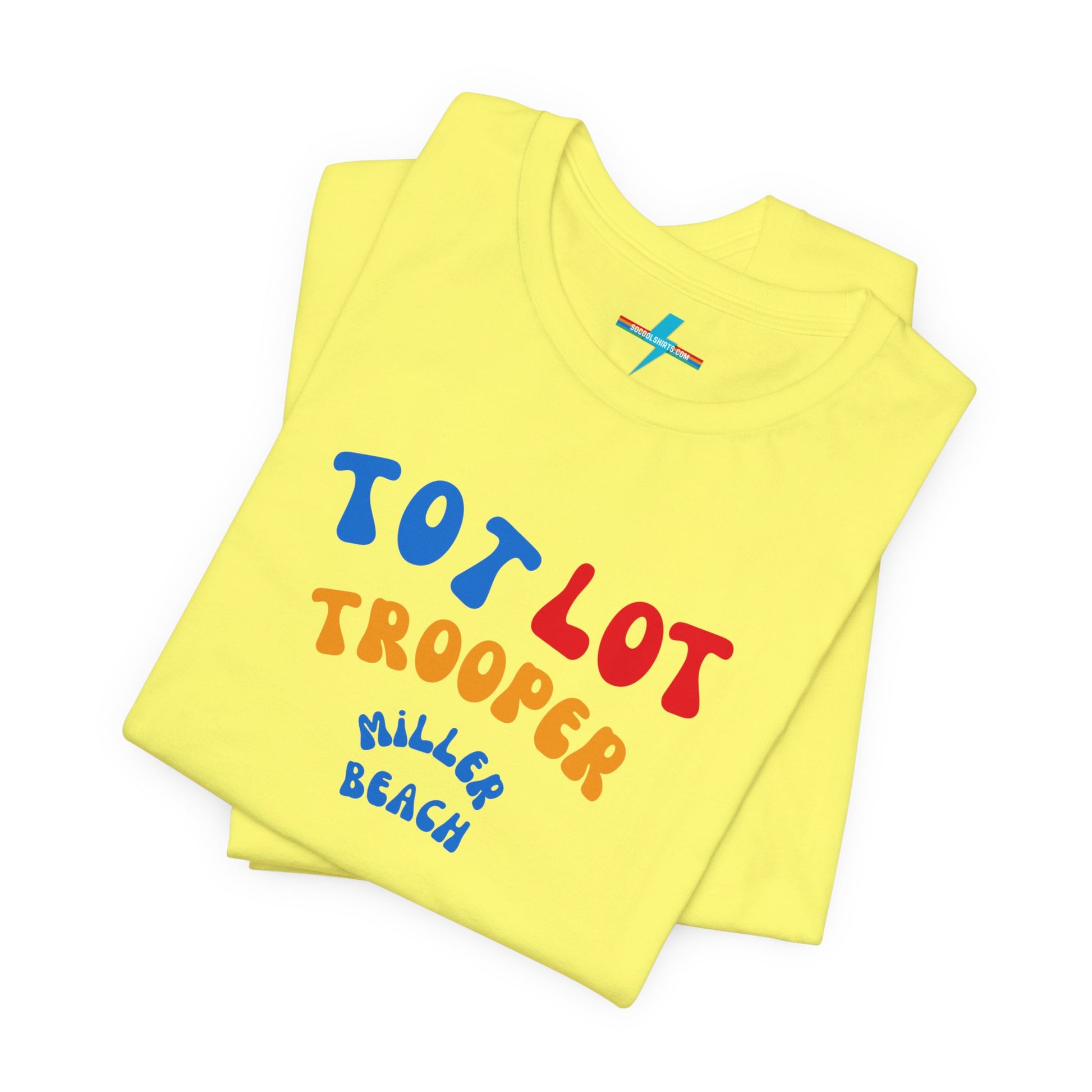 A green unisex jersey short sleeve tee from Printify, featuring colorful text on the front that reads "TOT LOT TROOPER MILLER BEACH" in blue, red, yellow, and orange letters. The shirt is displayed against a plain white background.