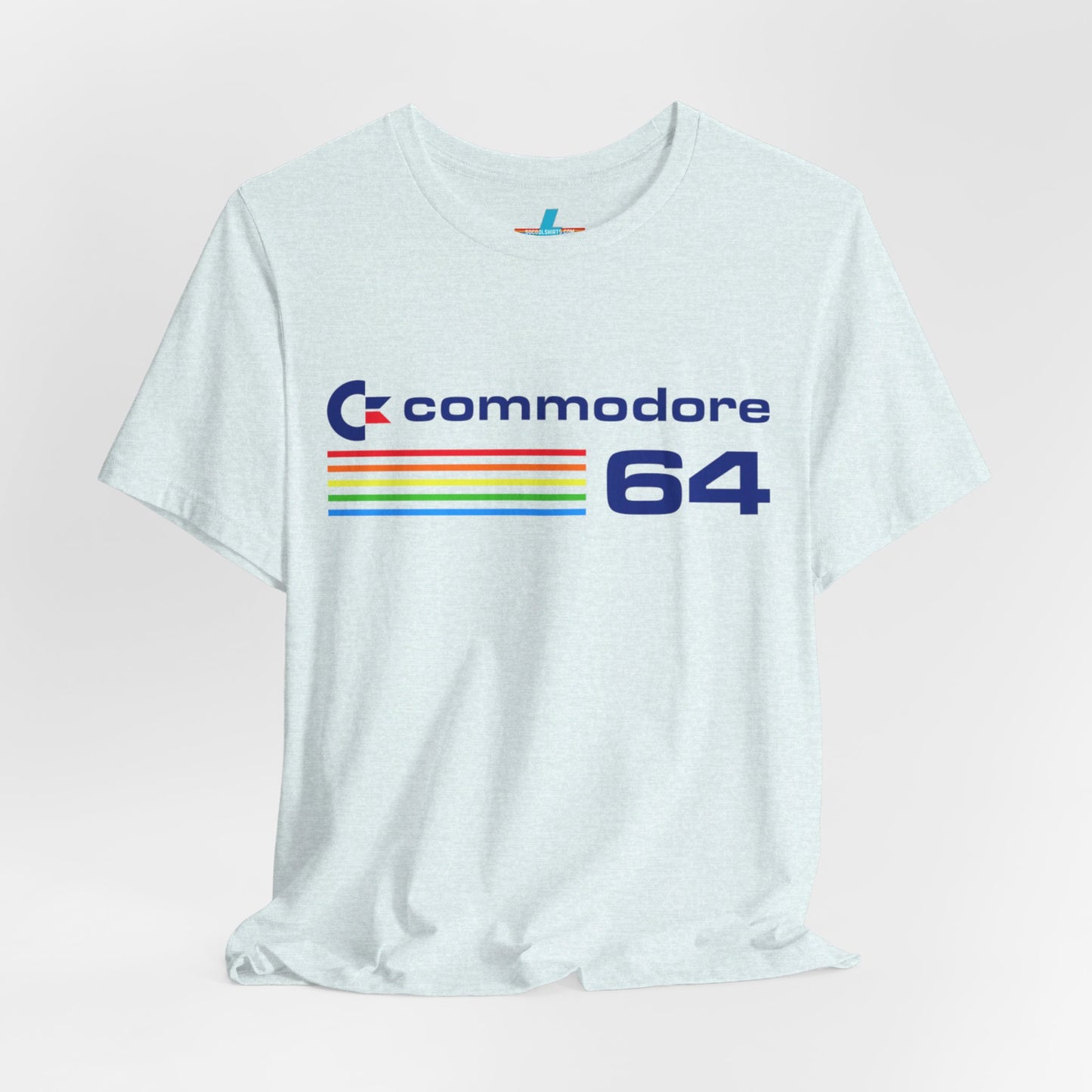 The 1980s Commodore 64 Computer C64 Unisex Jersey Short Sleeve Tee from Printify features a green T-shirt adorned with a vintage design showcasing the text "Commodore 64" and multicolored horizontal lines next to it. The word "Commodore" is emblazoned in blue alongside the Commodore logo, while the number "64" is also highlighted in blue on the right. Ideal for any retro tech enthusiast, this shirt is displayed against a white background.