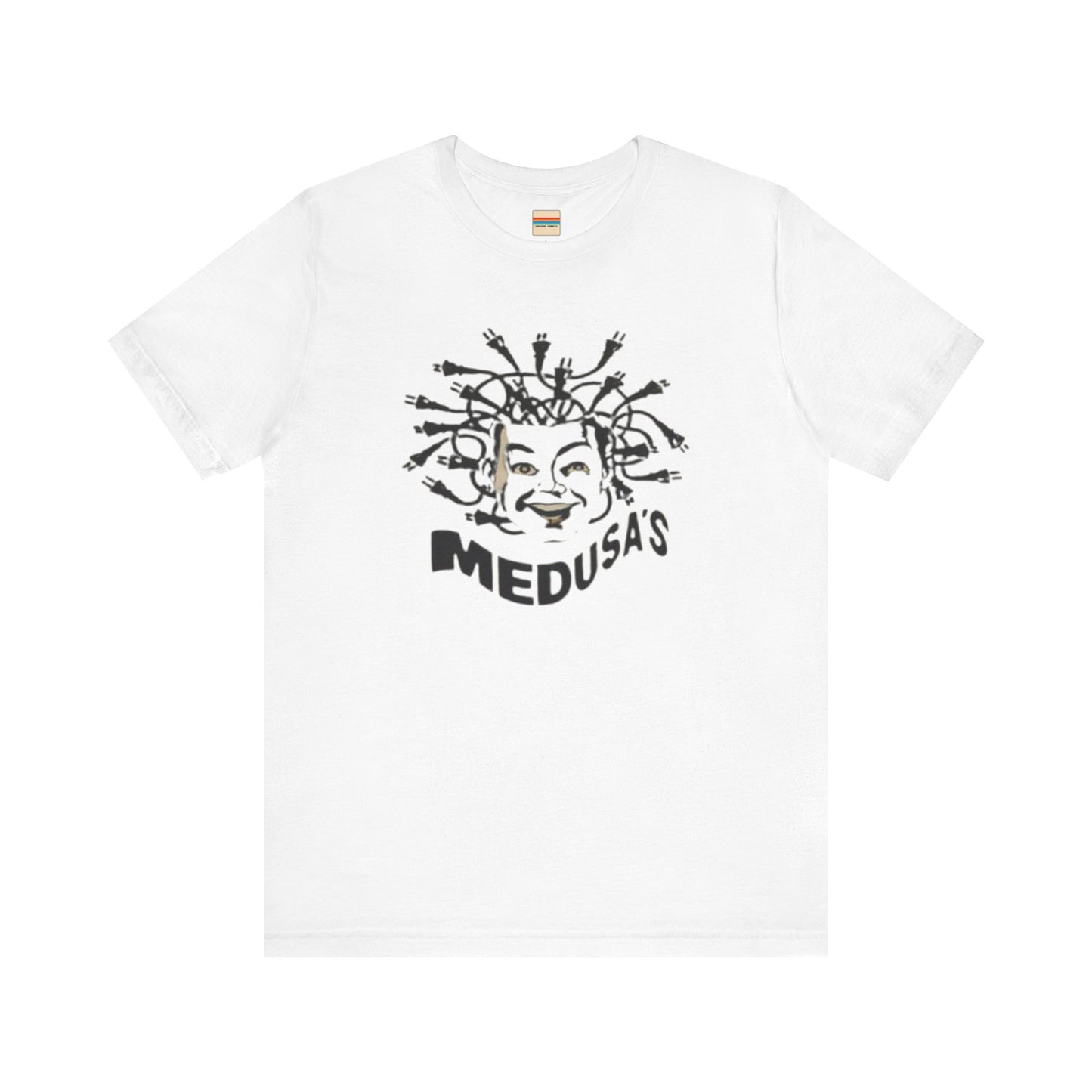 A cream-colored unisex jersey short sleeve tee from Printify, titled "Medusa's 1980s Dance Club Chicago," features a black and white illustration of a cartoonish Medusa head. The soft cotton design showcases numerous snakes as hair with a smiling face. Below, the word "MEDUSA'S" is printed in bold, playful font.